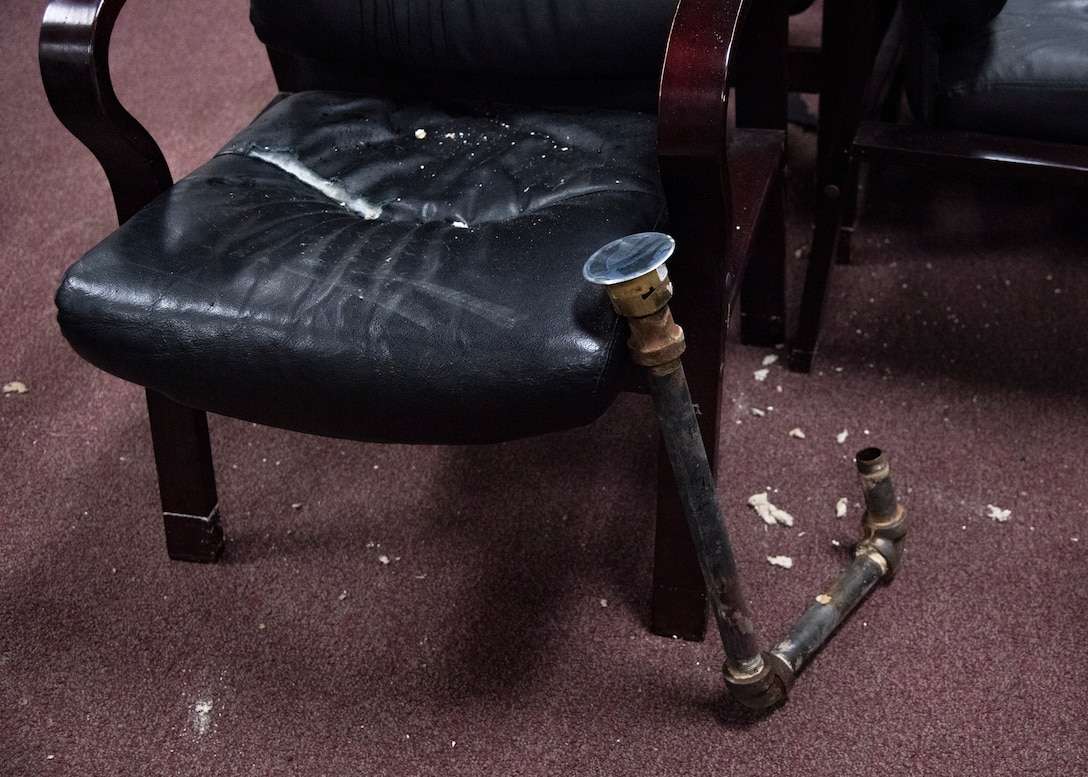 Damaged furniture and broken sprinklers sit in the Aerospace Ground Equipment schoolhouse at Sheppard Air Force Base, Texas, March 4, 2021. The Feb. 14, 2021, snowstorm damaged the AGE schoolhouse leaving it defunct. Pipes bursting caused flooding. Some pipes connecting the sprinkler system would also break off and cause the sprinkler to fall through the ceiling. (U.S. Air Force photo by Senior Airman Pedro Tenorio)