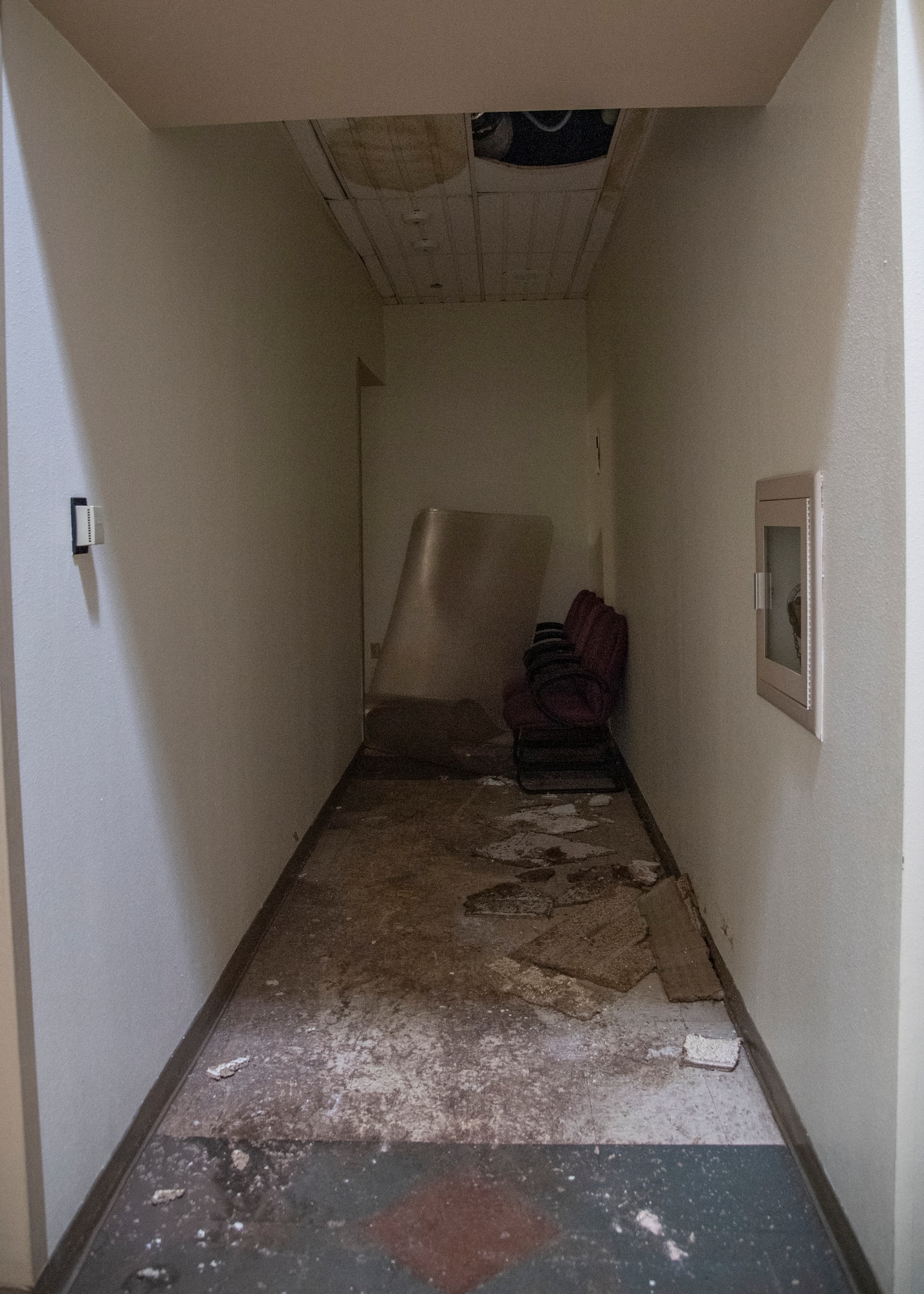 Damaged furniture and parts of the ceiling lay in a hallway in the Aerospace Ground Equipment schoolhouse at Sheppard Air Force Base, Texas, March 4, 2021. The Feb. 14, 2021, snowstorm damaged the AGE schoolhouse and left it defunct. Pipes bursting caused flooding to damage the building itself and the items inside of it. The pipes would also break off completely and fall through the ceiling. (U.S. Air Force photo by Senior Airman Pedro Tenorio)