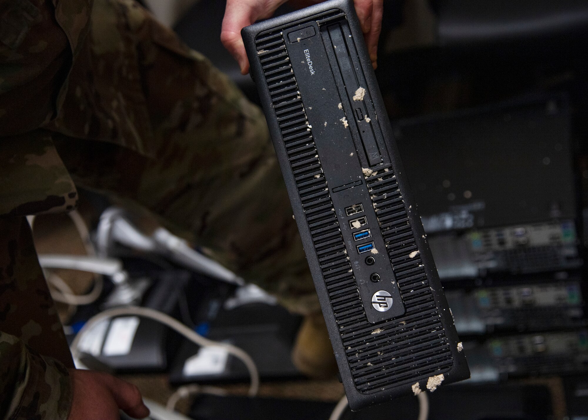 Master Sgt. Gabriel Bessette, 361st Training Squadron Aerospace Ground Equipment flight chief, holds one of their computers that was damaged by flooding at Sheppard Air Force Base, Texas, March 4, 2021. The snowstorm caused pipes to freeze then burst which caused flooding in parts of the AGE Tech. Training Schoolhouse. These computers were filled with water and drained when moved. It is most likely the data on these computers cannot be recovered. (U.S. Air Force photo by Senior Airman Pedro Tenorio)