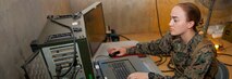 U.S. Marine Lance Cpl. Monique M. Szczepanski looks over mock terrain maps at Combat Town, Okinawa, Japan, Oct. 25, 2018. “I really love my job,” Szczepanski said. “I’m fairly new, so everything is a learning experience.” Szczepanski, a native of Johnson City, New York, is a geographic intelligence specialist with 3rd Intelligence Battalion, III Marine Expeditionary Force Information Group. 3rd Intel. Bn. is conducting the exercise to assess the abilities of their Marines in a field-like environment. (U.S. Marine Corps photo by Lance Cpl Kevan Dunlop)