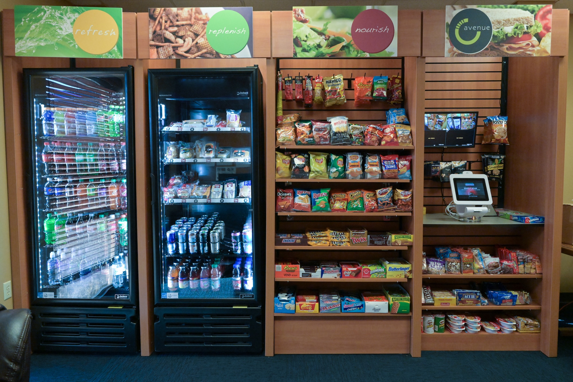 The recently installed Nano market installed in Montgomery Village consist of two refrigerated sections which holds cold drinks and food and two non-refrigerated sections containing dry snacks and microwavable items. The market is completely contactless, meaning airmen can purchase food through the digital payment system and not have to come in contact with other individuals, this provides a simple and safe option for hungry Airmen. (U.S. Air Force photo by Airman 1st Class Jessica Haynie)