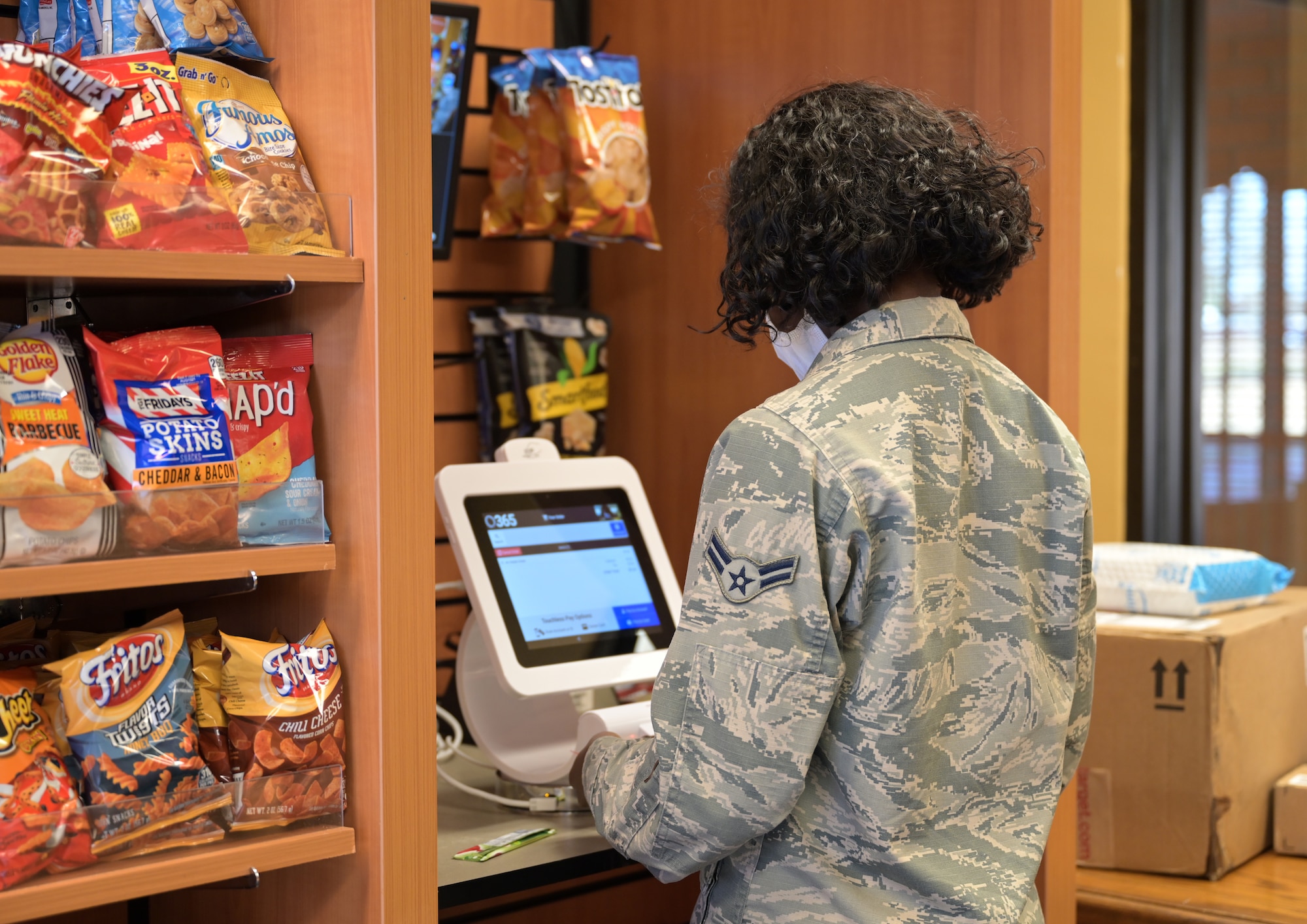 U.S. Air Force A1C Shamiya Brooks, 14th Communications Squadron knowledge management, purchases snacks from a recently installed Nano market inside Montgomery Village, Feb. 23, 2021, on Columbus Air Force Base, Miss. Montgomery Village is a common area provided to Airmen living in Unaccompanied Enlisted Housing, which consist of not only the new market, but also a small theater set-up, game room, music room, and study areas. (U.S. Air Force photo by Airman 1st Class Jessica Haynie)