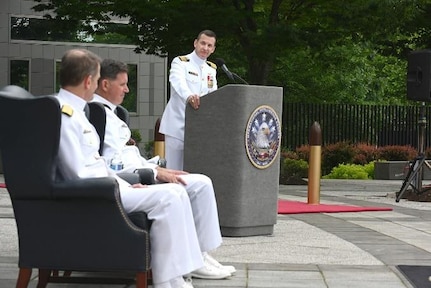 Capt. Hannan (right) address the audience for the first time as the commanding officer of the Nimitz Operational Intelligence Center.