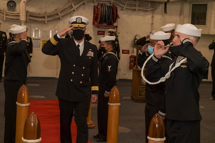 Rear Adm. Brendan McLane, commander, Naval Surface Force Atlantic (SURFLANT), salutes sideboys during the SURFLANT change of command ceremony aboard the San Antonio-class amphibious transport dock ship USS Mesa Verde (LPD 19).