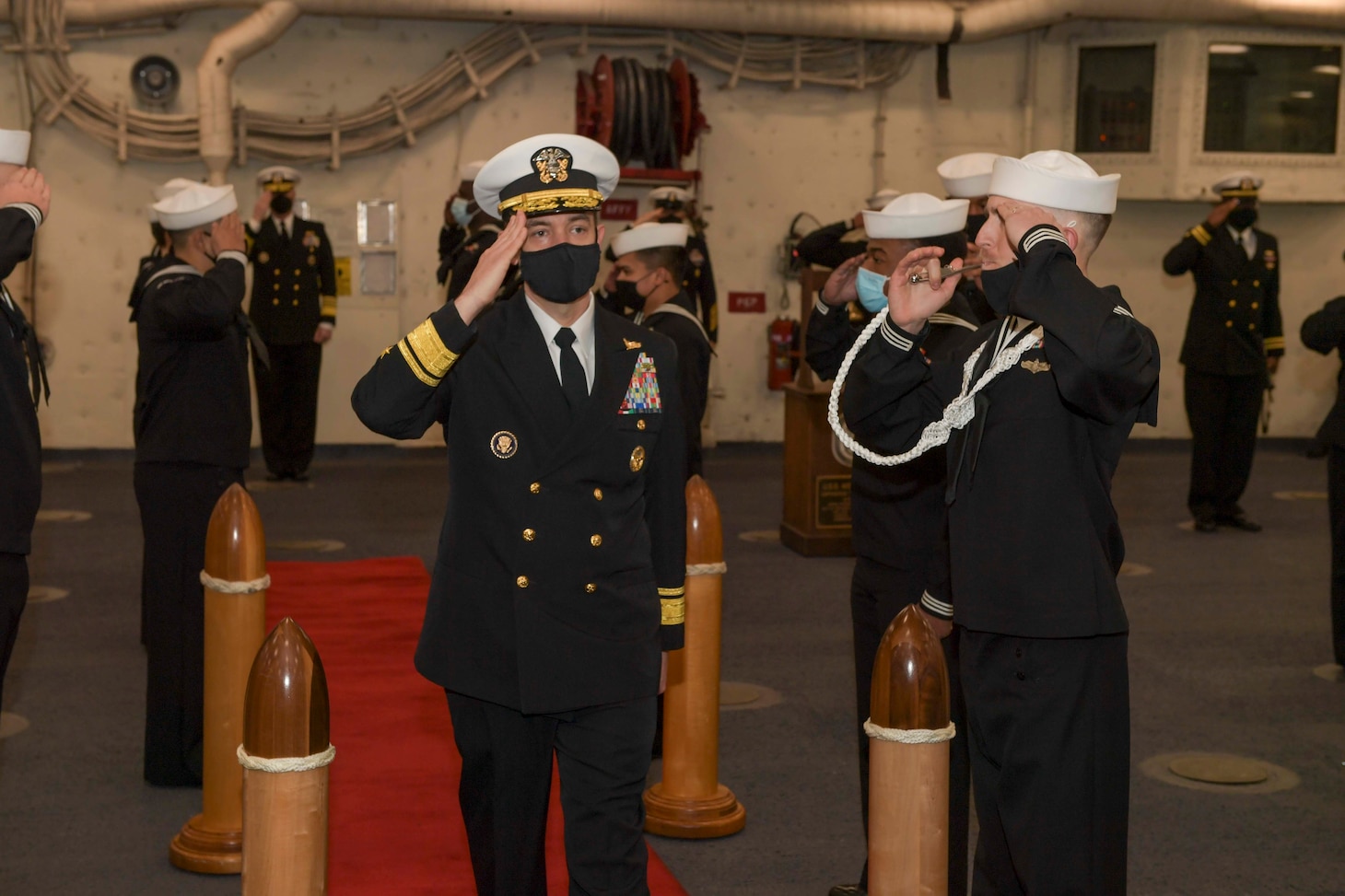 Rear Adm. Brad Cooper salutes sideboys during the Naval Surface Force Atlantic (SURFLANT) change of command ceremony aboard the San Antonio-class amphibious transport dock ship USS Mesa Verde (LPD 19).