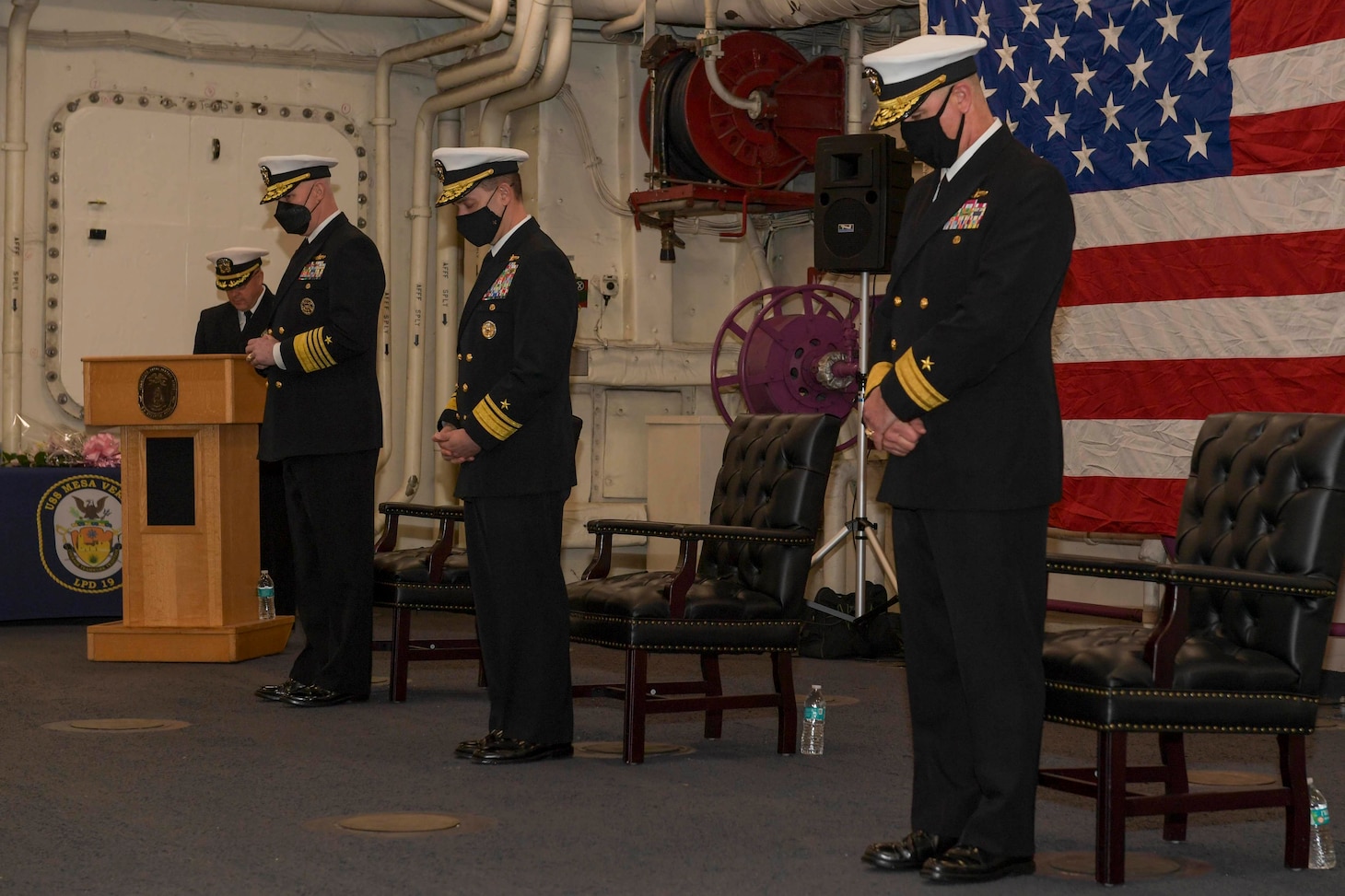 Adm. Christopher W. Grady, commander, U.S. Fleet Forces Command, Rear Adm. Brad Cooper, and Rear Adm. Brendan McLane, commander, Naval Surface Force Atlantic (SURFLANT) bow their heads during the SURFLANT change of command ceremony aboard the San Antonio-class amphibious transport dock ship USS Mesa Verde (LPD 19).