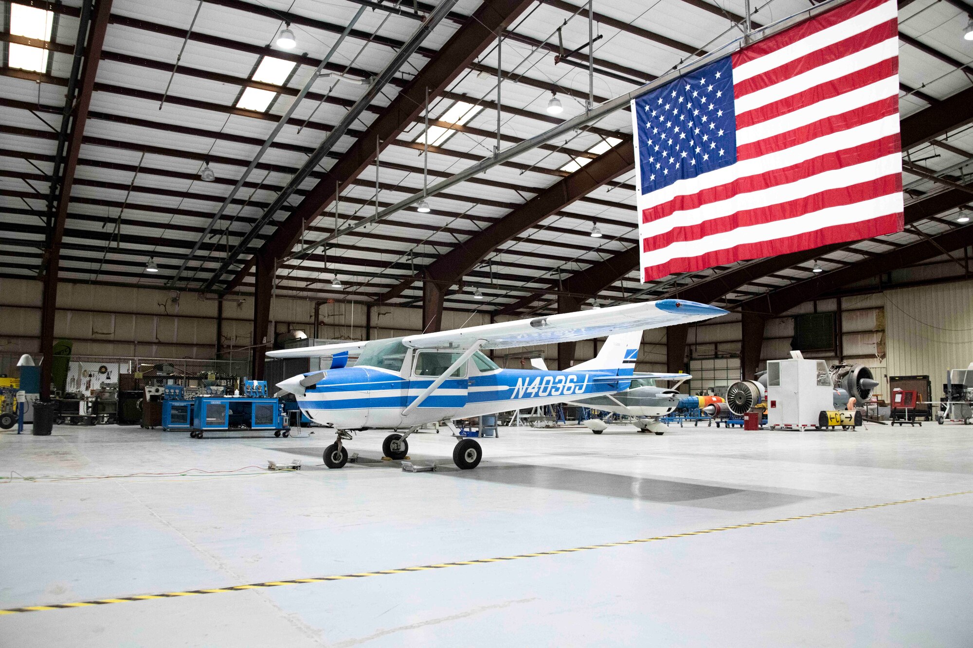 a plane sits in a hangar.