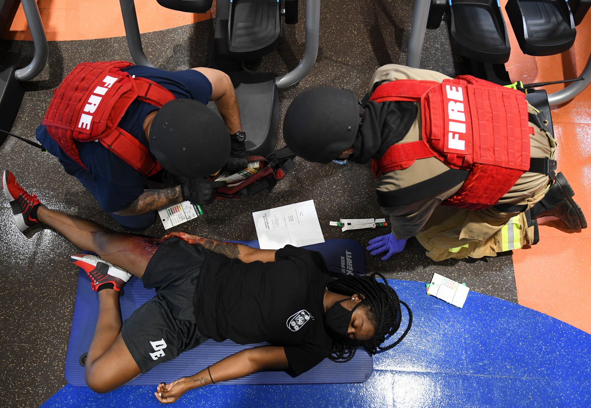 Jose Moreno, left, and Staff Sgt. Domitrius Johnson, right, 56th Civil Engineer Squadron firefighters, triage a simulated victim during an exercise Feb. 26, 2021, at Luke Air Force Base, Arizona. Firefighters assessed the simulated victims before medical teams arrived on the scene of the exercise, which evaluated the training, readiness and capability of Luke Airmen to respond to an active shooter threat on the installation. Exercises ensure Airmen meet warfighting needs with a continuous drive toward more effective and efficient training. (U.S. Air Force photo by Staff Sgt. Amber Carter)