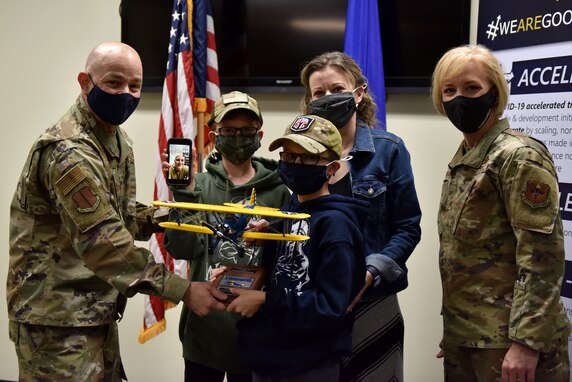 U.S. Air Force Col. Andres Nazario, 17th Training Wing commander and Chief Master Sgt. Casy Boomershine, 17th TRW command chief, present an annual award to the winner’s family while on a video call at the Security Forces building on Goodfellow Air Force Base, Texas, March 5, 2021. Wing leadership traveled to different organizations to present the 17th TRW 2020 Annual Awards. (U.S. Air Force photo by Staff Sgt. Seraiah Wolf)