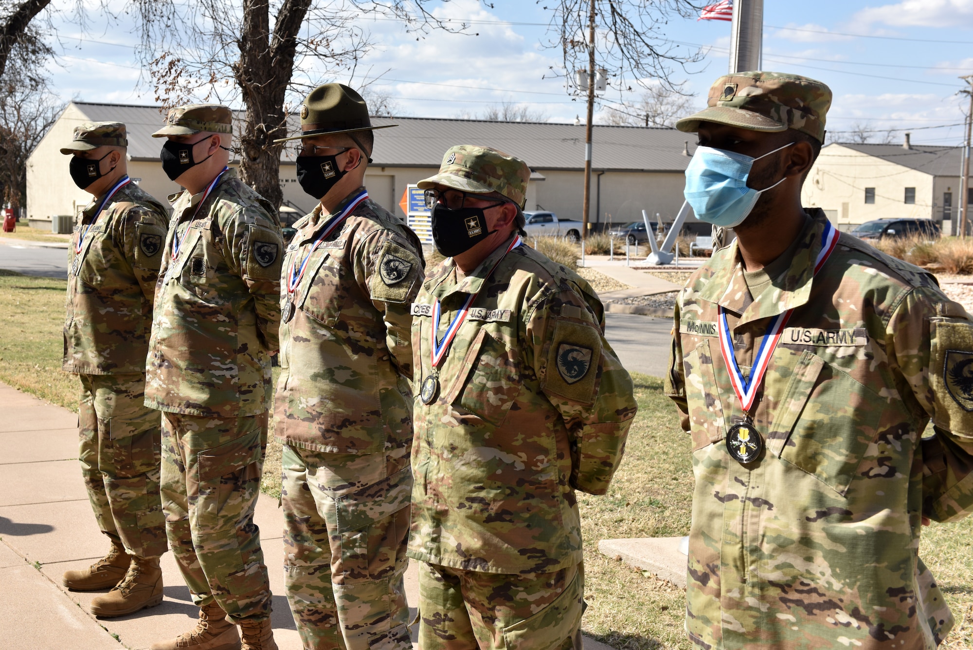 Soldier nominees for annual awards stand in formation waiting for the presentation of awards for the winners in front of the Vance-Nolan building on Goodfellow Air Force Base, Texas, March 5, 2021. Multiple Soldiers won in their respective categories for the 17th Training Wing 2020 Annual Awards. (U.S. Air Force photo by Staff Sgt. Seraiah Wolf)