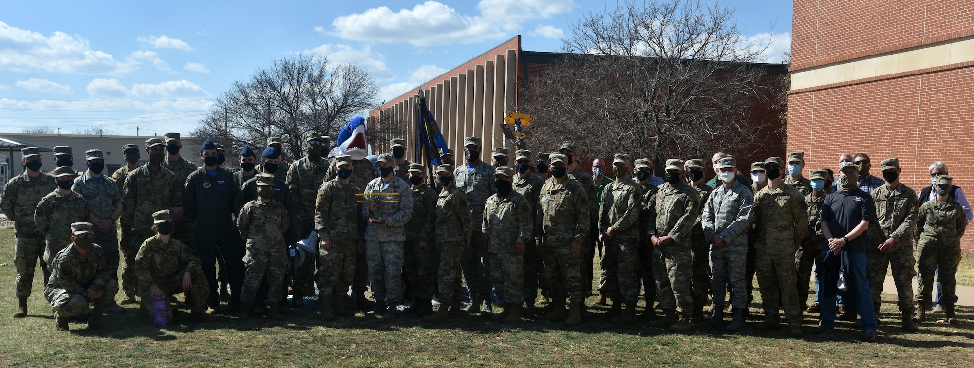 Members of the 316th Training Squadron gather for a photo outside of the 316th TRS schoolhouse during the presentation of the 17th TRW 2020 Annual Awards on Goodfellow Air Force Base, Texas, March 5, 2021. The 316th TRS won the 2020 unit of the year award. (U.S. Air Force photo by Senior Airman Ashley Thrash)
