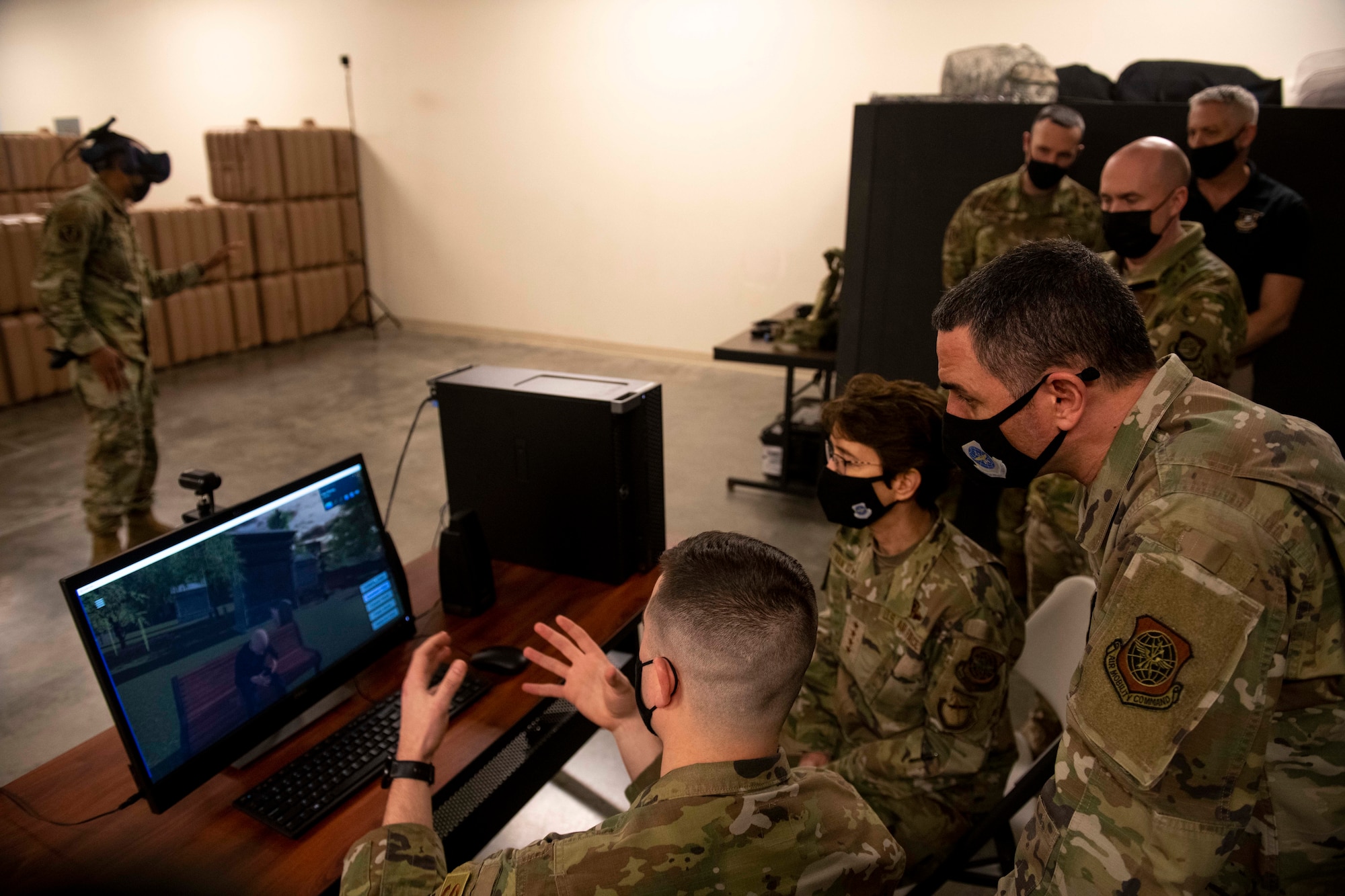 U.S. Air Force Gen. Jacqueline Van Ovost, Air Mobility Command commander, and Chief Master Sgt. Brian Kruzelnick, AMC command chief, watch a virtual use of force training demonstration at Fairchild Air Force Base, Washington, March 3, 2021. The AMC command team participated in a hands-on, shoot and move demonstration with the 92nd SFS and spoke with Fairchild defenders about their contribution to the AMC mission. (U.S. Air Force photo by Senior Airman Lawrence Sena)