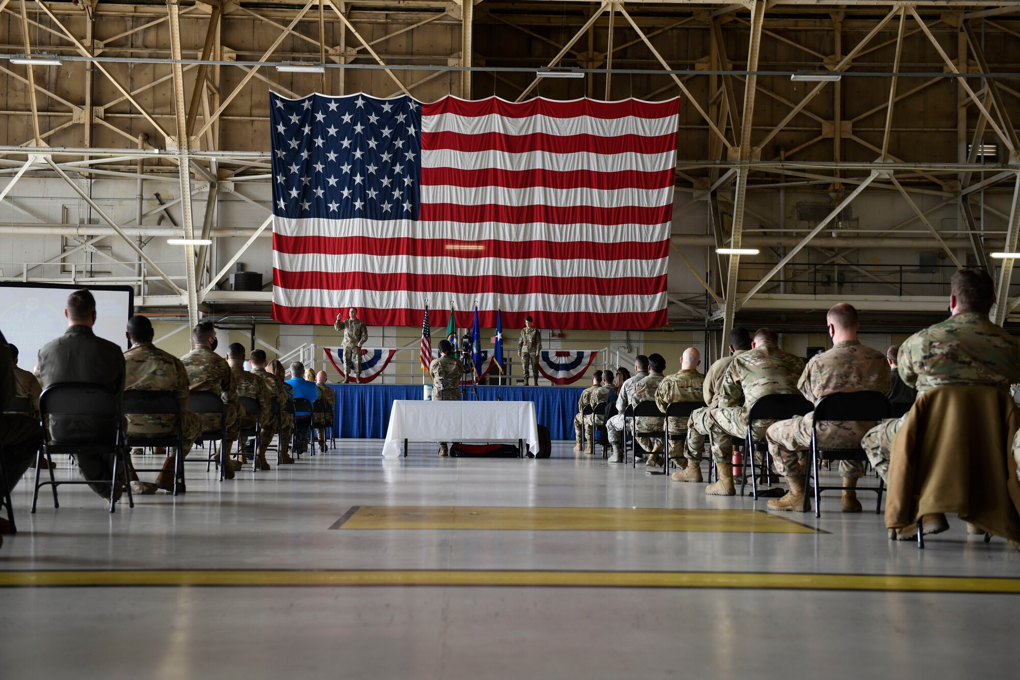 U.S. Air Force Gen. Jacqueline Van Ovost, Air Mobility Command commander, and Chief Master Sgt. Brian Kruzelnick, AMC command chief, address Fairchild Airmen during an all-call at Fairchild Air Force Base, Washington, March 4, 2021. The AMC command team spoke with Fairchild Airmen about the importance of diversity and inclusion, innovation and accelerating change in order to better the mobility mission. (U.S. Air Force photo by Senior Airman Lawrence Sena)