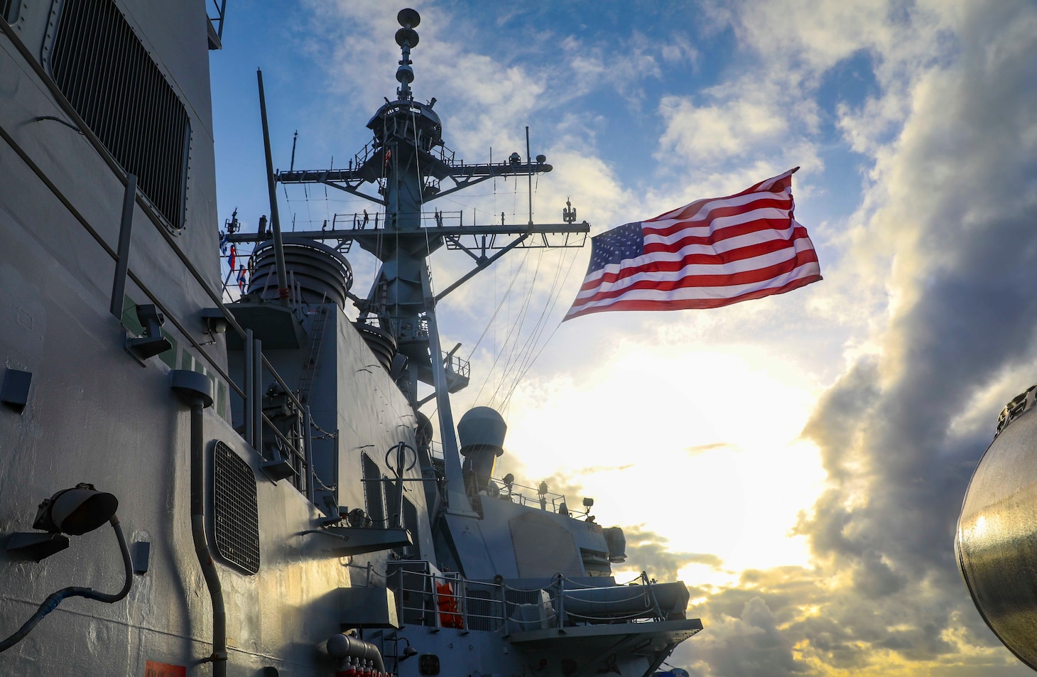 210301-N-FO714-1057 PHILIPPINE SEA (March 1, 2021) - The Arleigh Burke-class guided-missile destroyer USS Benfold (DDG 65) flies the Battle Ensign underway during the annual U.S.-Japan Bilateral Advanced Warfighting Training Exercise. BAWT focuses on joint training and interoperability of coalition forces, and enables real-world proficiency and readiness in response to any contingency. (U.S. Navy photo by Mass Communication Specialist 2nd Class Deanna C. Gonzales)