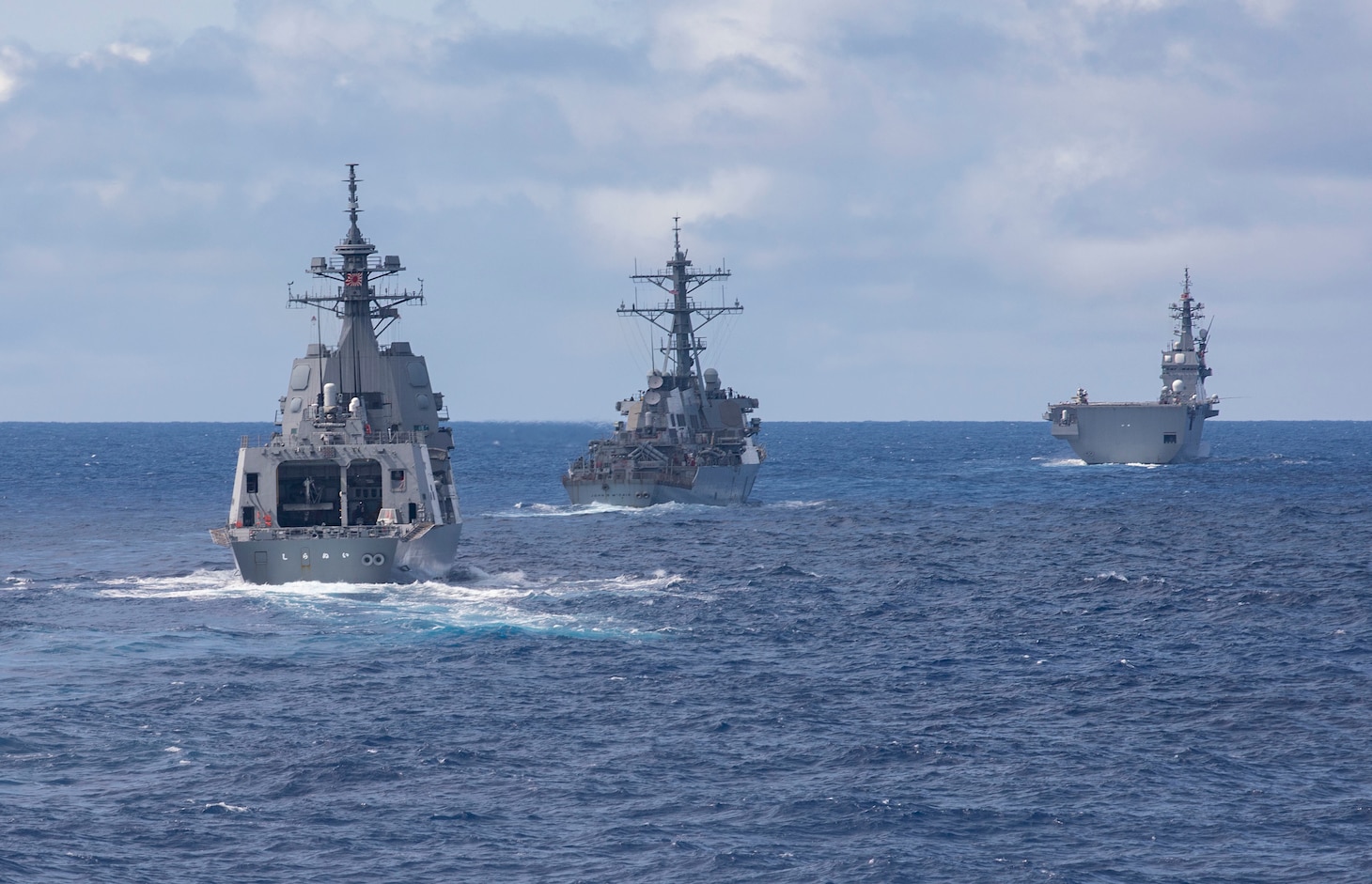 The Arleigh Burke-class guided-missile destroyer USS John S. McCain (DDG 56), the Japan Maritime Self-Defense Force guided-missile destroyer JS Shiranui (DDG 120) and helicopter destroyer JS Ise (DDH 182) sail in formation during the annual U.S.-Japan Bilateral Advanced Warfighting Training Exercise.