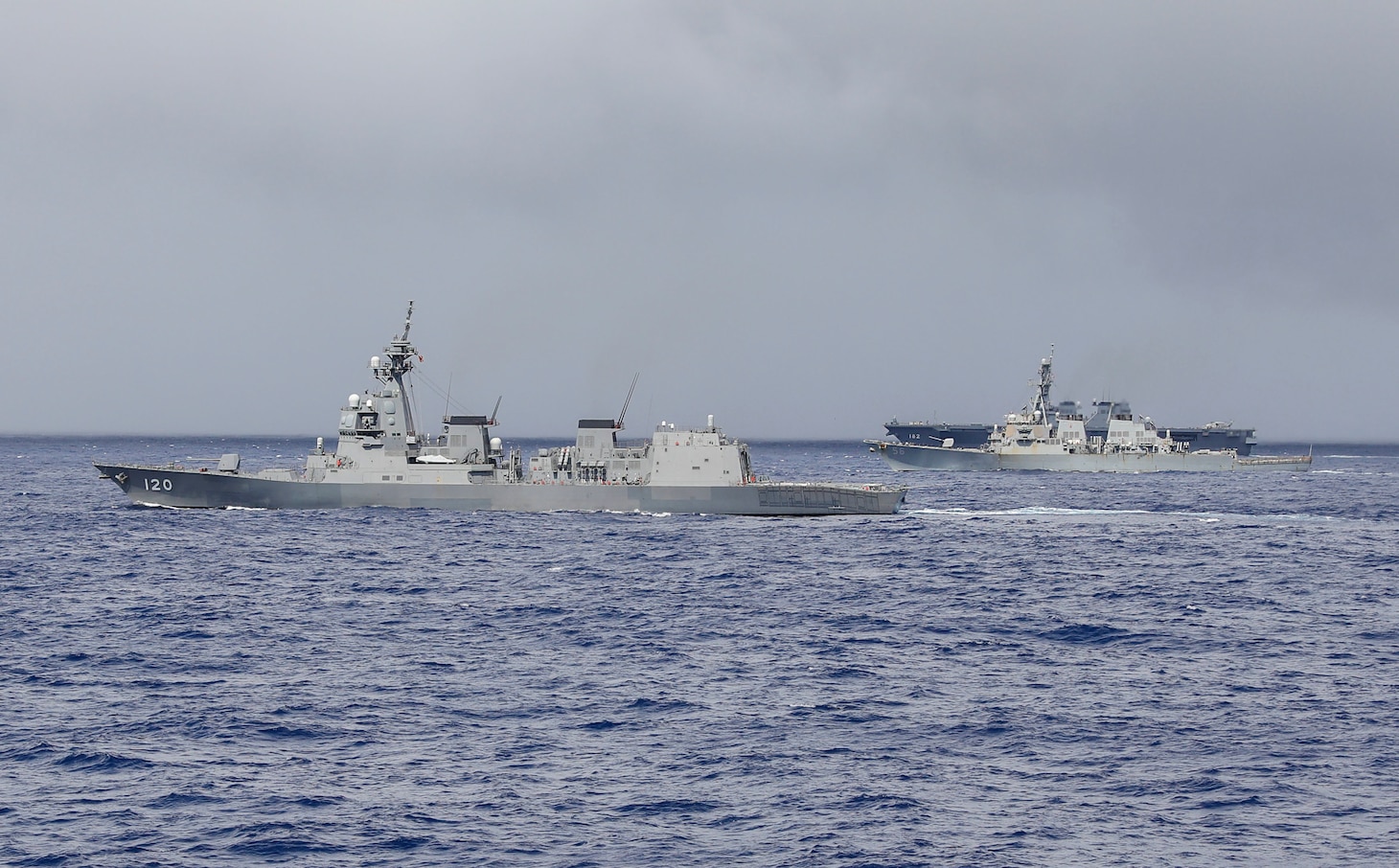 The Arleigh Burke-class guided-missile destroyer USS John S. McCain (DDG 56), the Japan Maritime Self-Defense Force guided-missile destroyer JS Shiranui (DDG 120) and helicopter destroyer JS Ise (DDH 182) sail in formation during the annual U.S.-Japan Bilateral Advanced Warfighting Training Exercise.