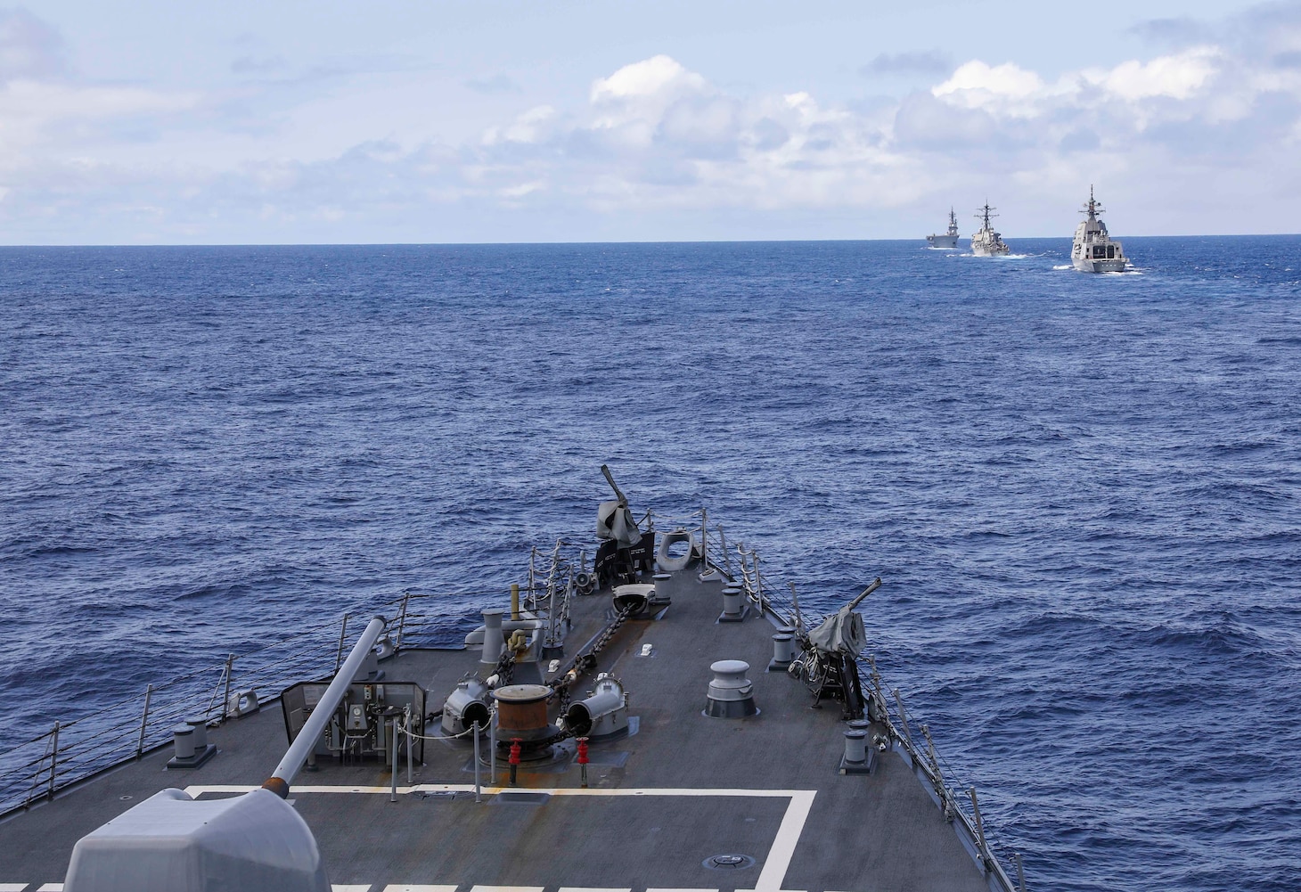 The Arleigh Burke-class guided-missile destroyers USS Benfold (DDG 65) and USS John S. McCain (DDG 56) sail in formation with the Japan Maritime Self-Defense Force guided-missile destroyer JS Shiranui (DDG 120) and helicopter destroyer JS Ise (DDH 182) during the annual U.S.-Japan Bilateral Advanced Warfighting Training Exercise.