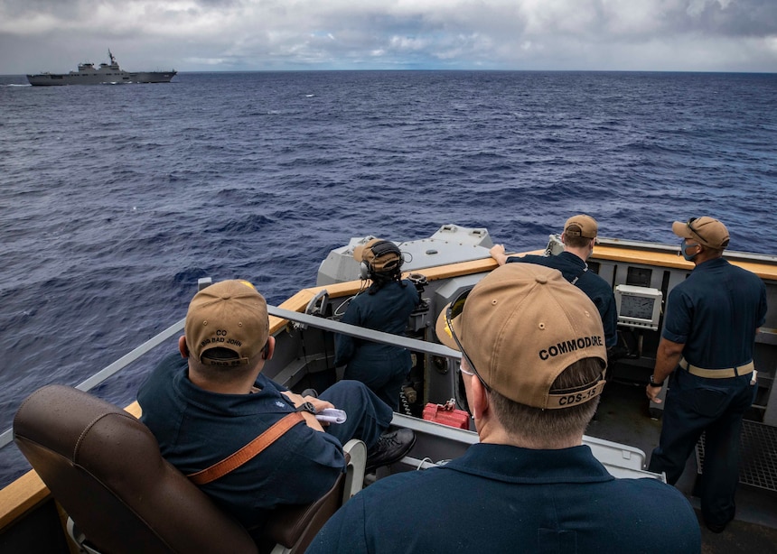 Capt. Chase Sargeant, commodore of Destroyer Squadron (DESRON) 15, and Cmdr. Tin Tran, commanding officer of the Arleigh Burke-class guided-missile destroyer USS John S. McCain (DDG 56), observe a group maneuvering exercise with ships assigned to Destroyer Squadron (DESRON) 15 and the Japan Maritime Self-Defense Force (JMSDF) during the annual U.S.-Japan Bilateral Advanced Warfighting Training exercise.