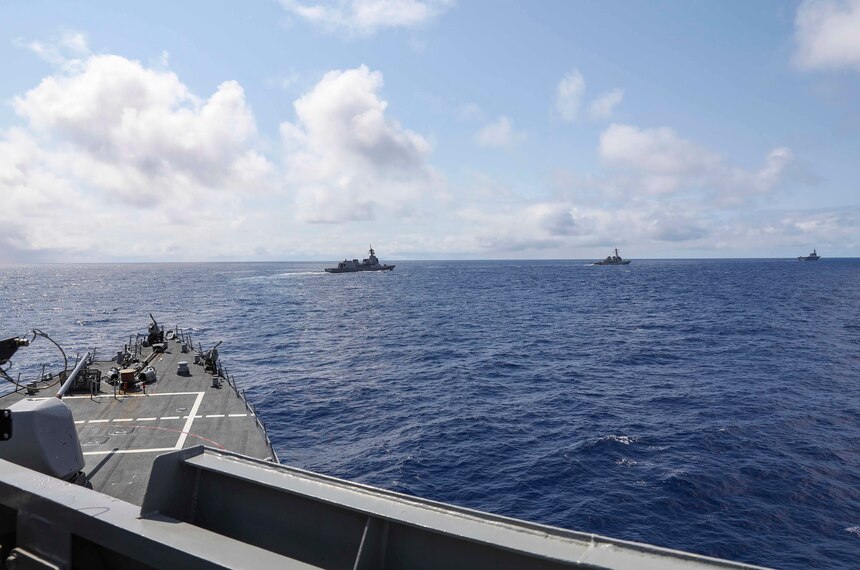 USS Benfold (DDG 65) and USS John S. McCain (DDG 56) sail in formation with the Japan Maritime Self-Defense Force guided-missile destroyer JS Shiranui (DDG 120) and helicopter destroyer JS Ise (DDH 182) during the annual U.S.-Japan Bilateral Advanced Warfighting Training Exercise.