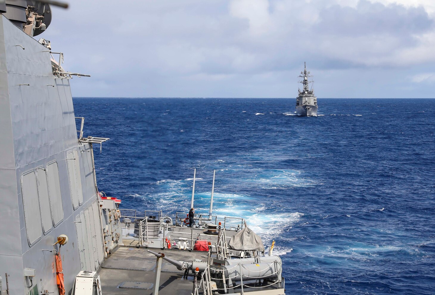 The Arleigh Burke-class guided-missile destroyer USS Benfold (DDG 65) sails in formation with the Japan Maritime Self-Defense Force missile destroyer JS Harusame (DD 102) during the annual U.S.-Japan Bilateral Advanced Warfighting Training Exercise.