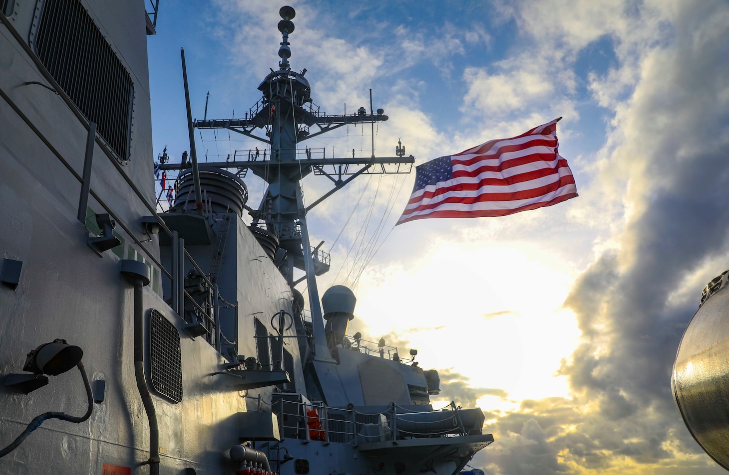 The Arleigh Burke-class guided-missile destroyer USS Benfold (DDG 65) flies the Battle Ensign underway during the annual U.S.-Japan Bilateral Advanced Warfighting Training Exercise.