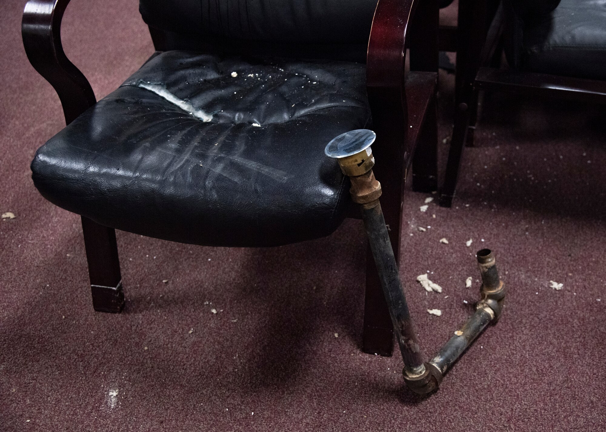 Damaged furniture and broken sprinklers sit in the Aerospace Ground Equipment schoolhouse at Sheppard Air Force Base, Texas, March 4, 2021. The Feb. 14, 2021, snowstorm damaged the AGE schoolhouse leaving it defunct. Pipes bursting caused flooding. Some pipes connecting the sprinkler system would also break off and cause the sprinkler to fall through the ceiling. (U.S. Air Force photo by Senior Airman Pedro Tenorio)