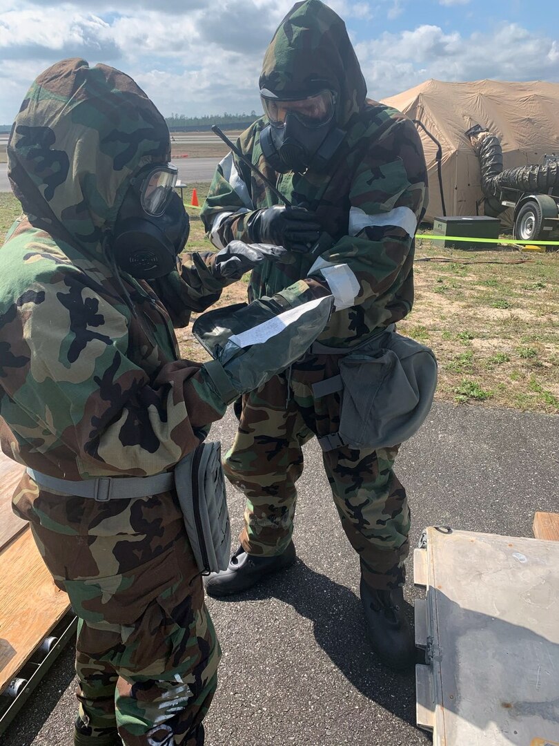 433rd Contingency Response Flight members, Tech. Sgt. Amy Lewis and Tech. Sgt. Jared Bull, conduct chemical, biological, radioactive, nuclear, and explosive protection training during Exercise Patriot Sands Feb. 25, 2021 at the Tallahassee airport. Military members practice these skills to enable continued operations in contaminated environments. (Courtesy photo)