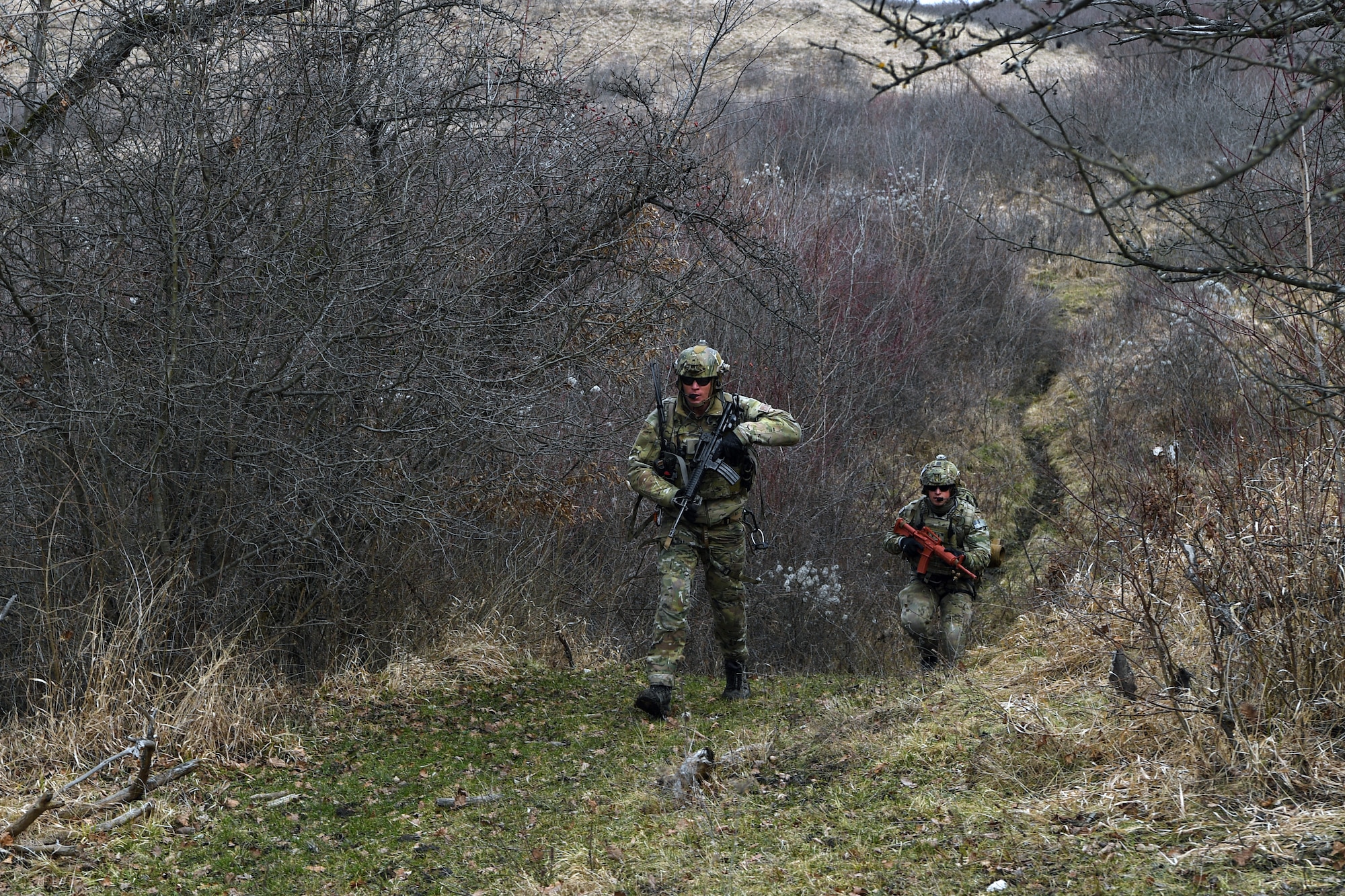 Two pararescuemen with the 57th Rescue Squadron search for a downed pilot during Operation Porcupine in Romania, March 4, 2021.