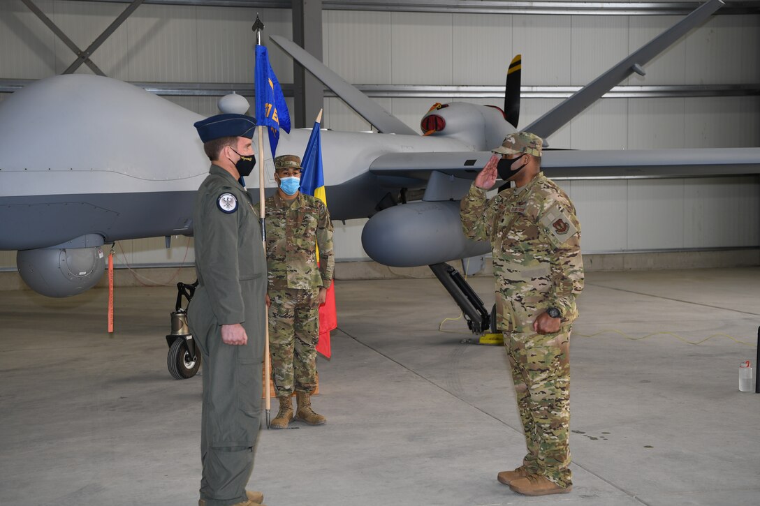 U.S. Air Force Lt. Col. Michawn Yuvieno, 731st Expeditionary Attack Squadron commander salutes U.S. Air Force Col. Leslie Hauck, 31st Operations Group commander during an activation and assumption of command ceremony at Camp Turzii, Romania, March 4, 2021. The newly activated 731st EATKS contains MQ-9 Reaper aircraft as well, as over 90 Airmen to maintain, launch, recover and control them. (U.S. Air Force photo by Airman 1st Class Thomas S. Keisler IV)