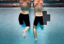 French Army Sergents Chef Jocelyn Truchet, from Modam, France, and Erwan Camel, from Tarbes, France, Wounded Warriors with the Allies Team, rest on the pool wall and listen to the instruction of Coach Shiela Taormina, a 1996 Olympic gold medalist, during practice for the
2012 Marine Corps Trials at Marine Corps Base Camp Pendleton, Calif., Feb. 15, 2012. Wounded Warrior Marines, veterans and allies are competing in the second annual trials, which include swimming, wheelchair basketball, sitting volleyball, track and field, archery and shooting. The top 50 performing Marines will earn the opportunity to compete in the Wounded Warrior Games in Colorado Springs in May.