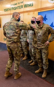 Army Gen. Daniel Hokanson greets Air Force Chief Master Sgt. Jeffery Stebbins during a visit to the Vermont Air National Guard's 158th Fighter Wing in South Burlington, Vermont, Feb. 26, 2021. Hokanson, the National Guard Bureau chief, honored Vermont Soldiers and Airmen for their recent accomplishments during his visit to the Green Mountain State. Stebbins is the 158th FW command chief. (U.S. Air National Guard photo by Mrs. Julie M. Paroline)