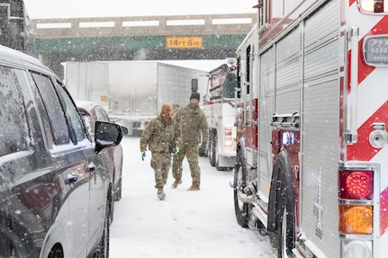 Staff Sgt. Josh Jacox, 2120th Engineer Company, 120th Engineering Battalion, Oklahoma Army National Guard and Spc. Parker Sargent, electrician specialist, 2120th Engineer Company, 120th Engineering Battalion, Oklahoma Army National Guard, assist motorists and Oklahoma Highway during a wreck in Stroud, Oklahoma. 

The Oklahoma Army National Guard, in partnership with the Oklahoma Highway Patrol, responded to severe weather conditions in Stranded Motorist Assistance Recovery Teams (SMART) made up of nearly 90 Soldiers. (U.S. Army National Guard photo by Pfc. Emily White)