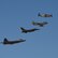 An F-22 Raptor, an F-16 Fighting Falcon, an F-86 Sabre and a P-51 Mustang in flight