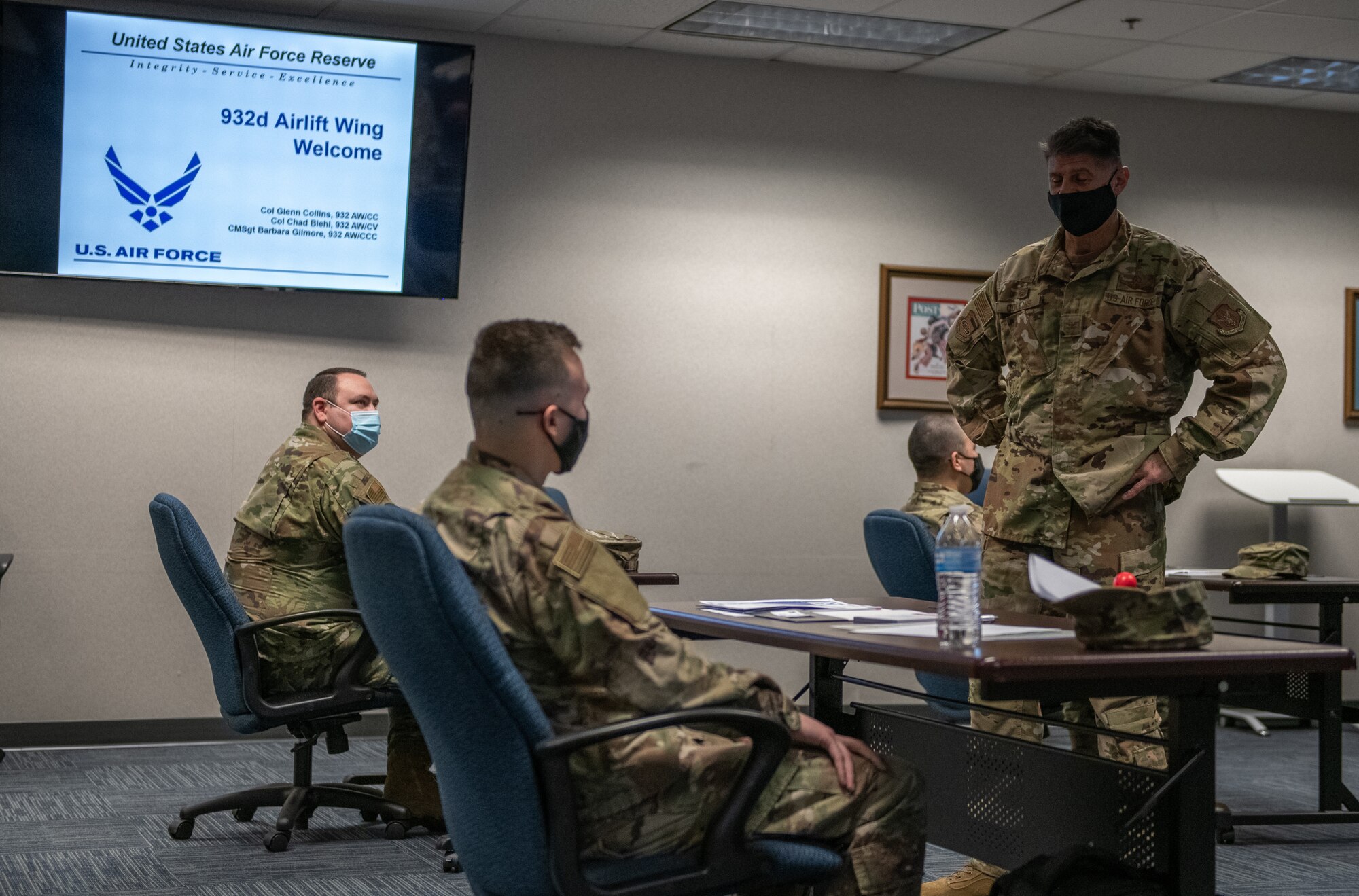 Col. Glenn Collins, 932nd Airlift Wing commander, meets with and asks each attendee about their backgrounds during the in-person Newcomers briefing, March 6, 2021, Scott Air Force Base, Illinois.  This was the first in-person Newcomers briefing since October due to COVID-19 restrictions. (U.S. Air Force photo by Master Sgt. Christopher Parr)