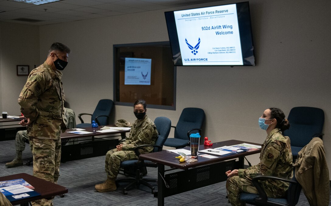 Col. Glenn Collins, 932nd Airlift Wing commander, meets with and asks each attendee about their backgrounds during the in-person Newcomers briefing, March 6, 2021, Scott Air Force Base, Illinois.  This was the first in-person Newcomers briefing since October due to COVID-19 restrictions. (U.S. Air Force photo by Master Sgt. Christopher Parr)