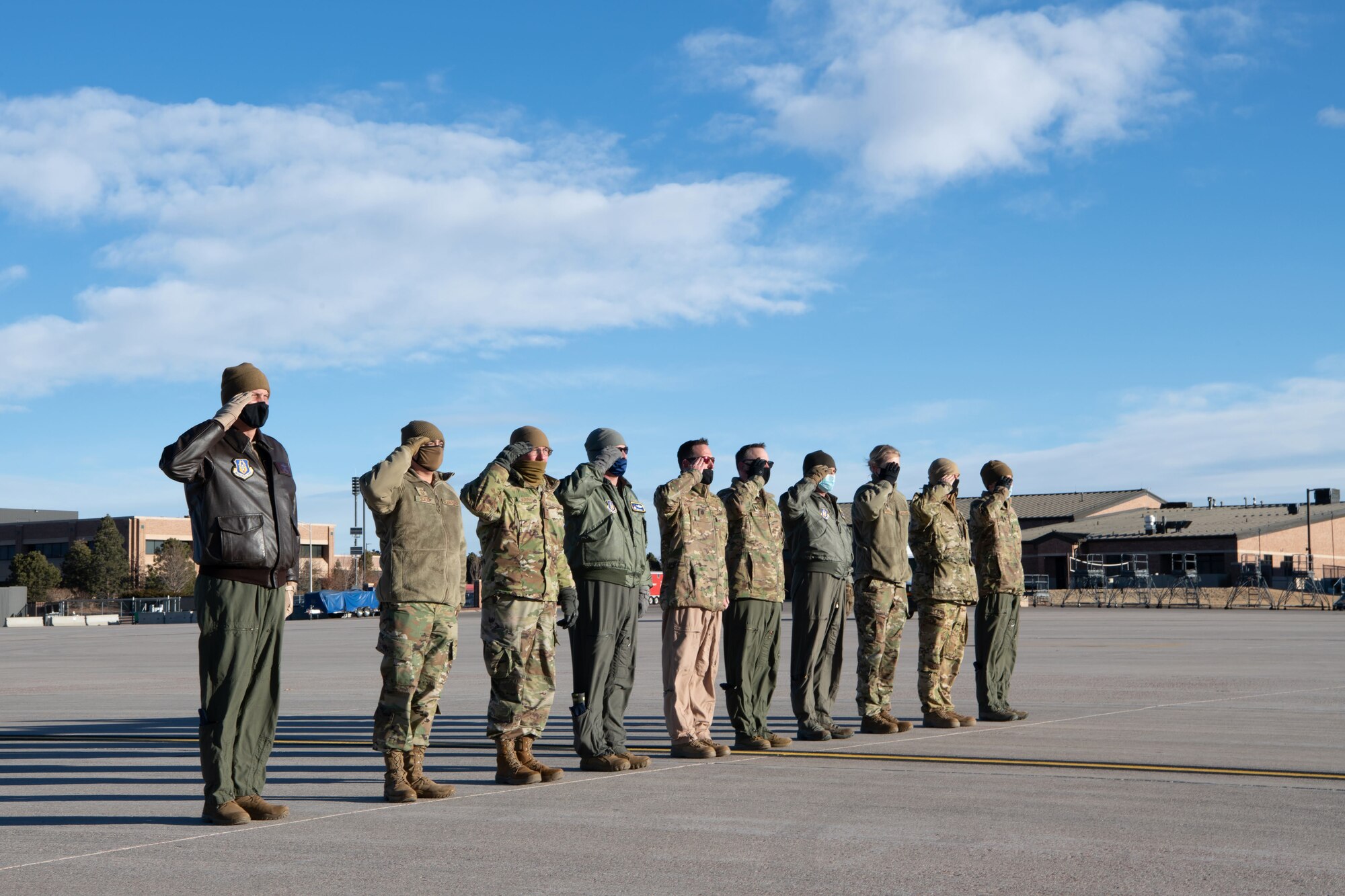 Leadership from the 302nd Airlift Wing deliver the final salute to members aboard a C-130 aircraft before they depart to an undisclosured location Feb. 5, 2021, Peterson Air Force Base, Colorado.