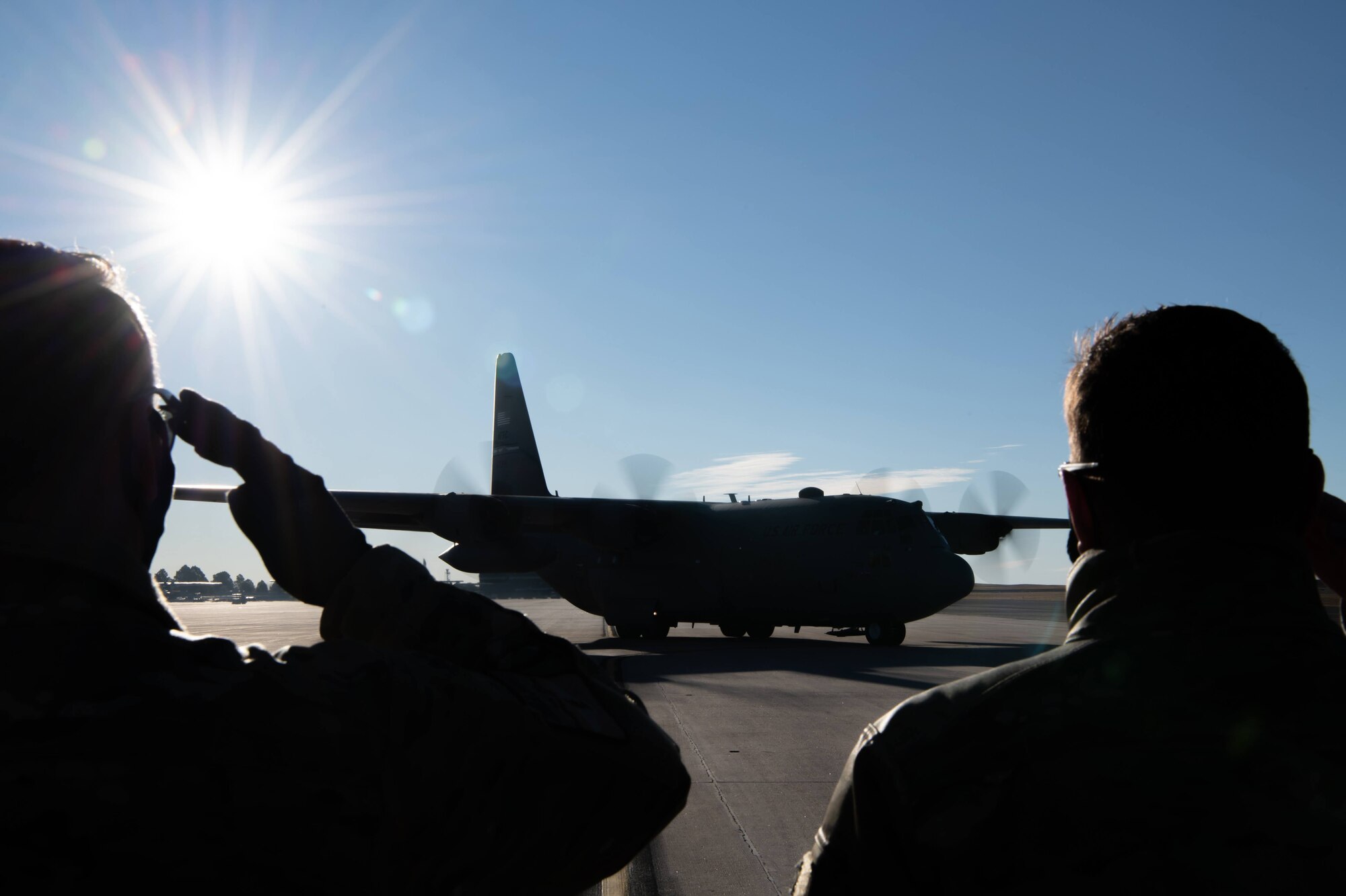 Leadership from the 302nd Airlift Wing deliver a salute to members aboard a C-130 aircraft before they depart to an undisclosured location Feb. 5, 2021, Peterson Air Force Base, Colorado.