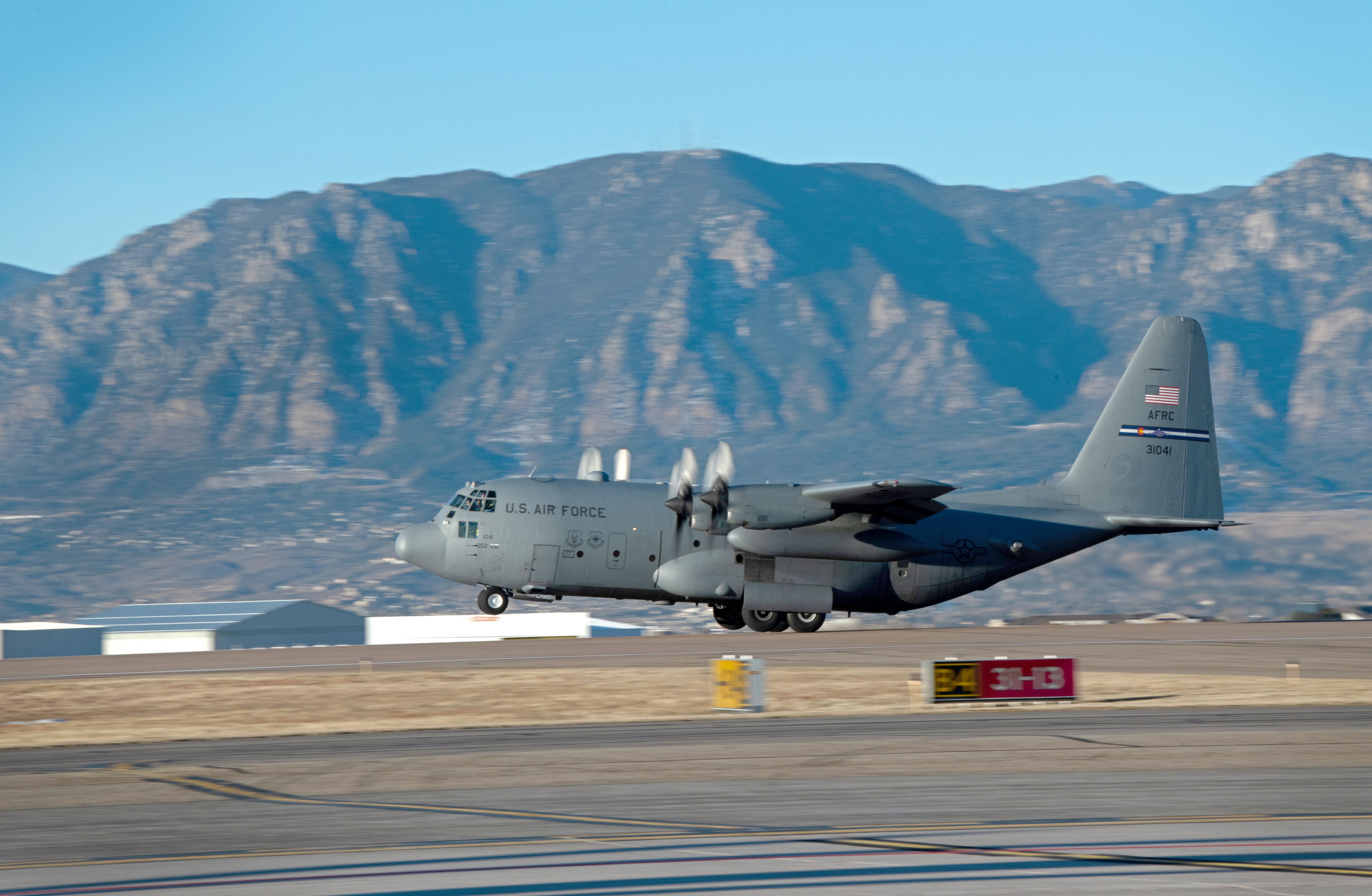 A C-130 carrying members of the 302nd Airlift Wing lifts off the runway in departure to an undisclosured location Feb. 5, 2021, Peterson Air Force Base, Colorado.