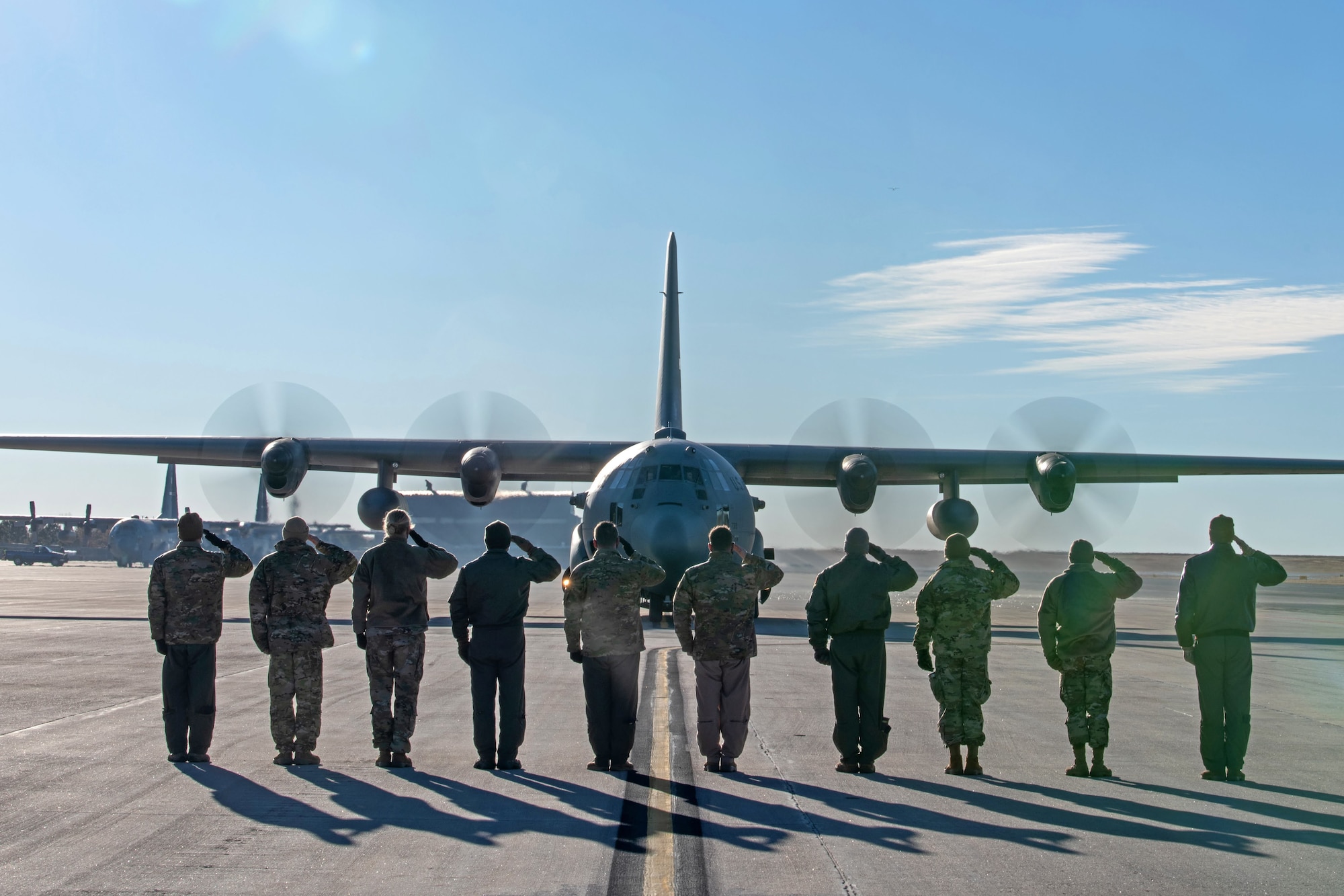 Leadership from the 302nd Airlift Wing deliver a salute to members aboard a C-130 aircraft before they depart to an undisclosured location Feb. 5, 2021, Peterson Air Force Base, Colorado.