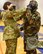 Tech. Sgt. Ellie Drake, 931st Civil Engineer Squadron Emergency Management technician, assists a McConnell Reservist with their M50 gas mask during a Chemical, Biological, Radiological and Nuclear survival skills training March 5, 2020, at McConnell Air Force Base, Kansas.