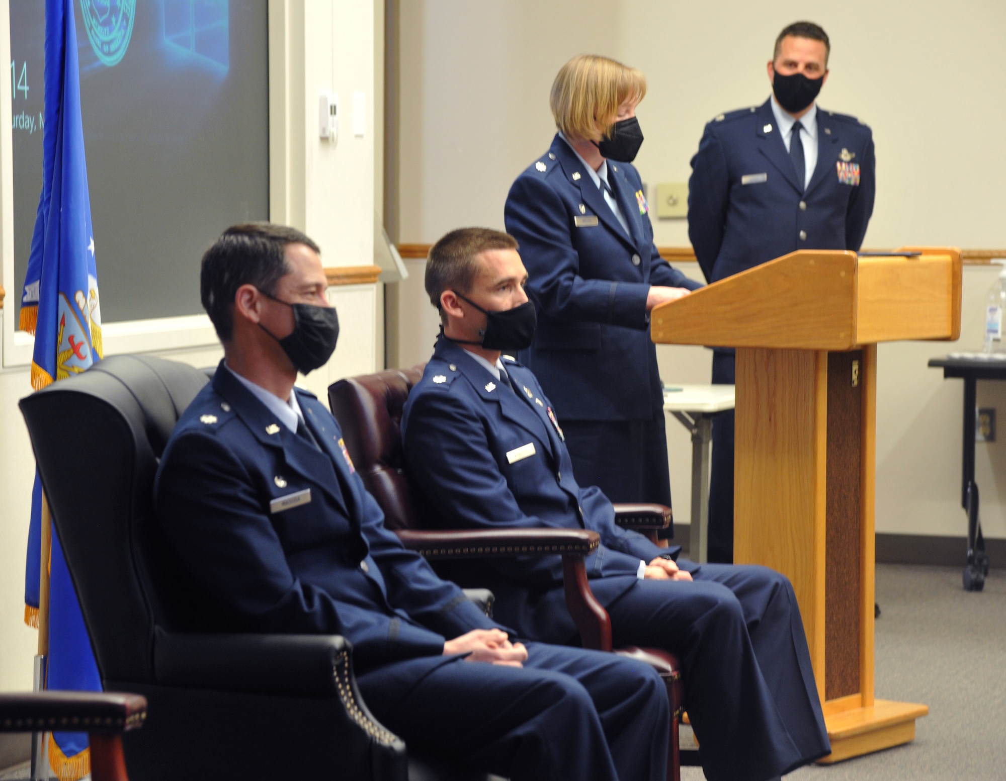 U.S. Air Force Lt. Col. Cynthia Welch, 446th Operations Group commander, officiates the 728th Airlift Squadron change of command March 6, 2021, on Joint Base Lewis-McChord, Washington, while outgoing and incoming commanders listen.