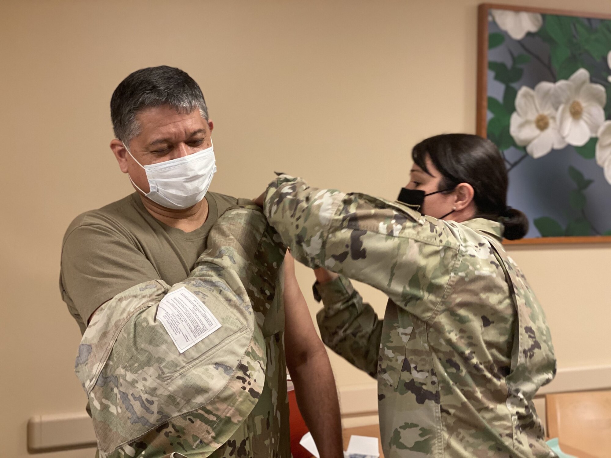 Tech. Sgt. Lisa Gonzales-Marin, 349th Aerospace Medical Squadron medical technician, administers a COVID-19 vaccination to Master Sgt. Julian Recendez, 349th Force Support Squadron training manager, at David Grant Medical Center at Travis Air Force Base, California, on Feb. 26, 2021. Reserve Citizen Airmen from the 349th Airlift Wing received their first COVID-19 vaccine during the March drill weekend. Each member receiving the vaccine was monitored for development of side effects and waited 15 minutes after getting the vaccine before they were allowed to leave. The two-dose vaccine was recently approved by the Food and Drug Administration under an emergency use authorization and are currently offered to Defense Department personnel on a voluntary basis. Reservists receiving the Moderna COVID-19 Vaccine will receive their second dosage 28 days after receiving the first dosage. (U.S. Air Force courtesy photo/Released)