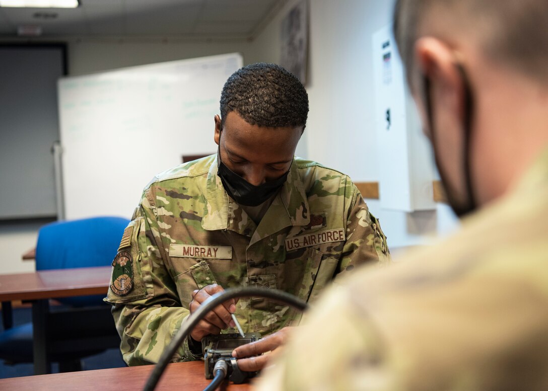 U.S. Air Force Staff Sgt. Wesley Murray, a cyber surety supervisor with the 644th Combat Communications Squadron, helps a customer at Andersen Air Force Base, Guam, Feb. 10, 2021. Murray was a part of a multi-capable deployable communications team within the 644 CBCS during his Air Force career. The unit is designed to deploy all or part of a 32-person team within a moment’s notice to establish and provide initial non-classified internet protocol router network and secret internet protocol router network services. (U.S. Air Force photo by Senior Airman Aubree Owens)
