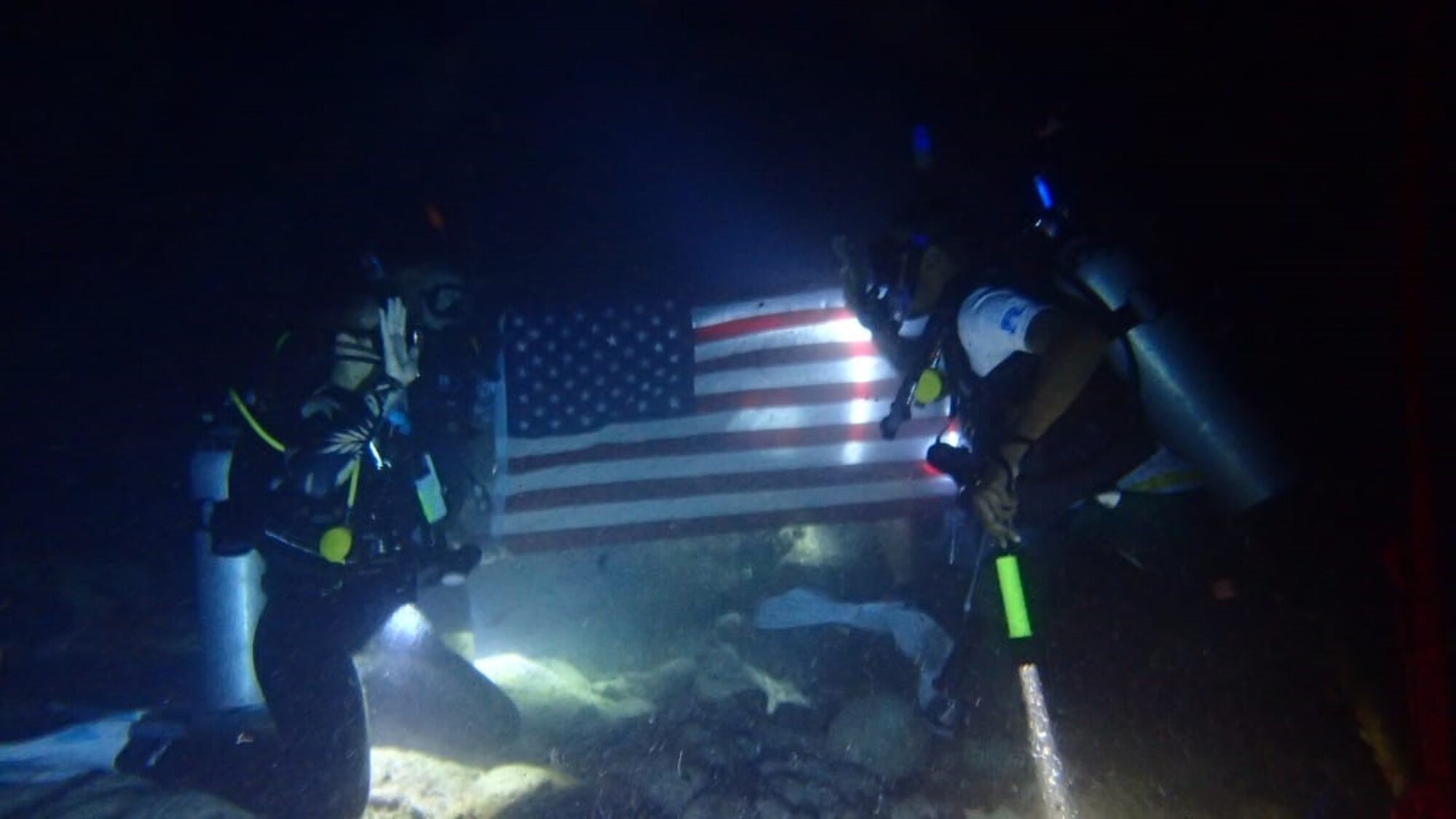 U.S. Air Force 1st Lt. Kaelyn Huizenga, officer in charge of Combat Support with the 644th Combat Communications Squadron, commences the enlistment of U.S. Air Force Staff Sgt. Wesley Murray, a cyber surety supervisor with the 644 CBCS, into the U.S. Space Force under water, Feb. 11, 2021. During his Air Force career, Murray served at three duty stations and four deployed locations, and was able to obtain seven certificates in various advancements benefiting every unit he was attached to. (Courtesy photo)