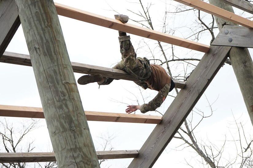 Sgt. Thaisen Nguyen, a Soldier from the 56th Stryker Brigade Combat Team, 28th Infantry Division, navigates the weaver obstacle during the obstacle course portion of the Pennsylvania Army National Guard's Best Warrior Competition on March 4, 2021, at Fort Indiantown Gap, Pa.