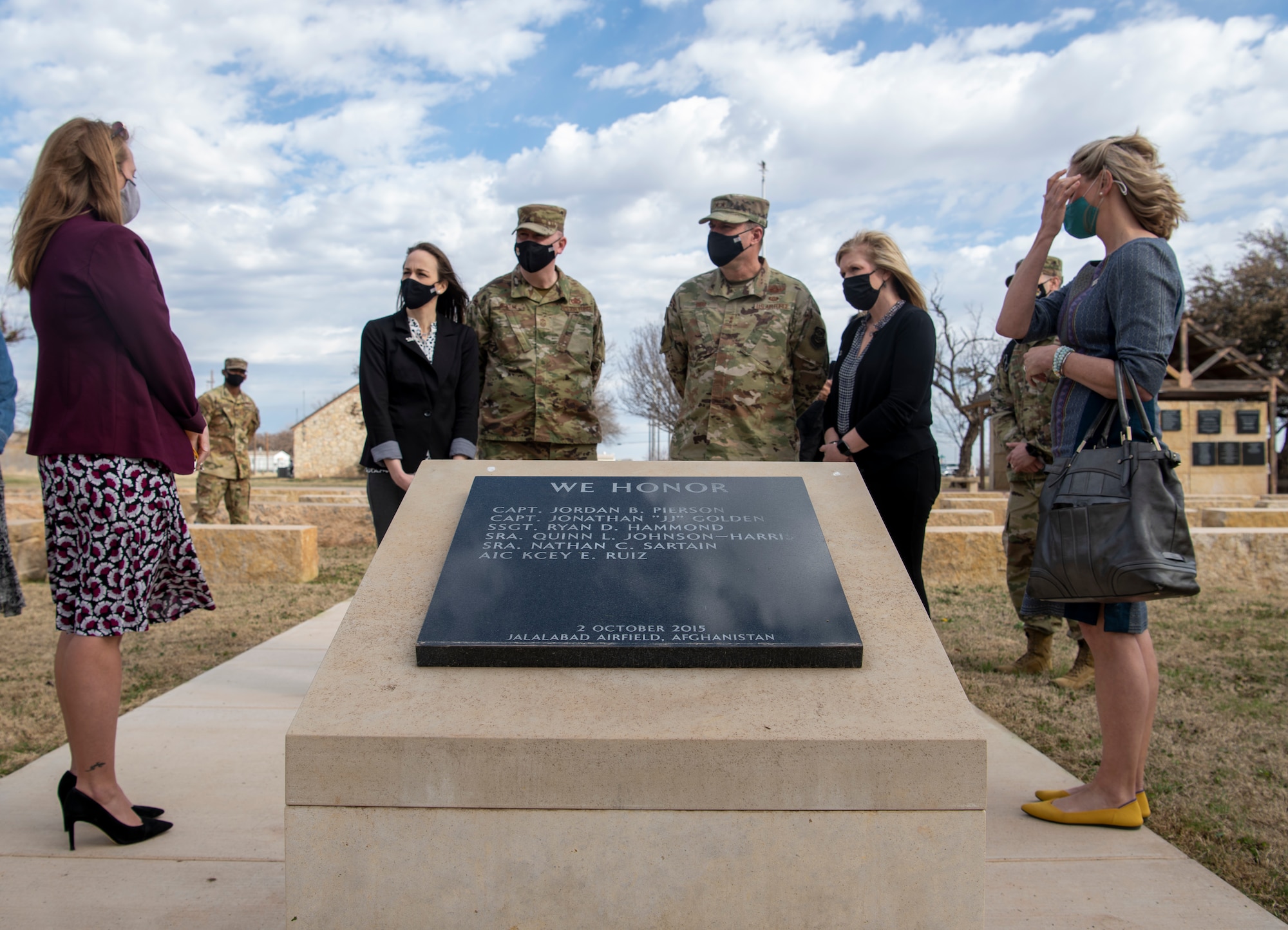 Key Spouses brief Maj. Gen. Thad Bibb, 18th Air Force commander, right, and Chief Master Sgt. Chad Bickley, 18th AF command chief, left, on the Dyess Memorial Park at Dyess Air Force Base, Texas, Mar. 4, 2021.