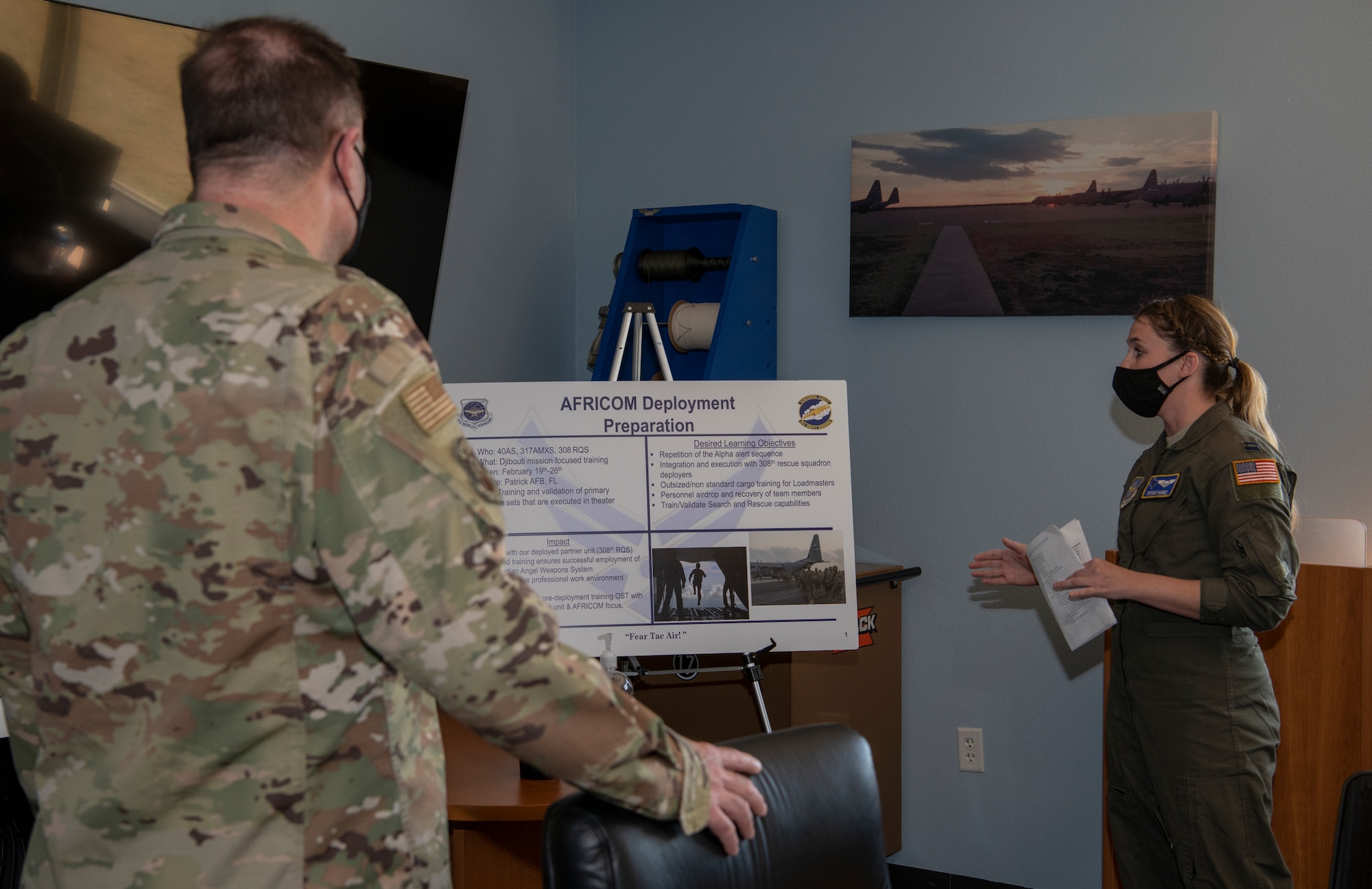 Capt. Tiffany Haines, 40th Airlift Squadron aircraft commander, briefs Maj. Gen. Thad Bibb, 18th Air Force commander, on their deployment training at Dyess Air Force Base, Texas, Mar. 3, 2021.