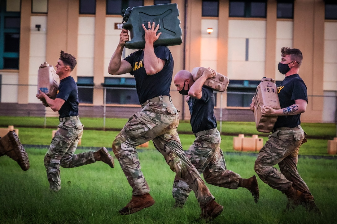 Soldiers run while carrying an object.