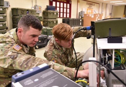 Soldiers assigned in support of the U.S. Army Medical Materiel Center-Korea perform maintenance on a medical device. (Courtesy U.S. Army)