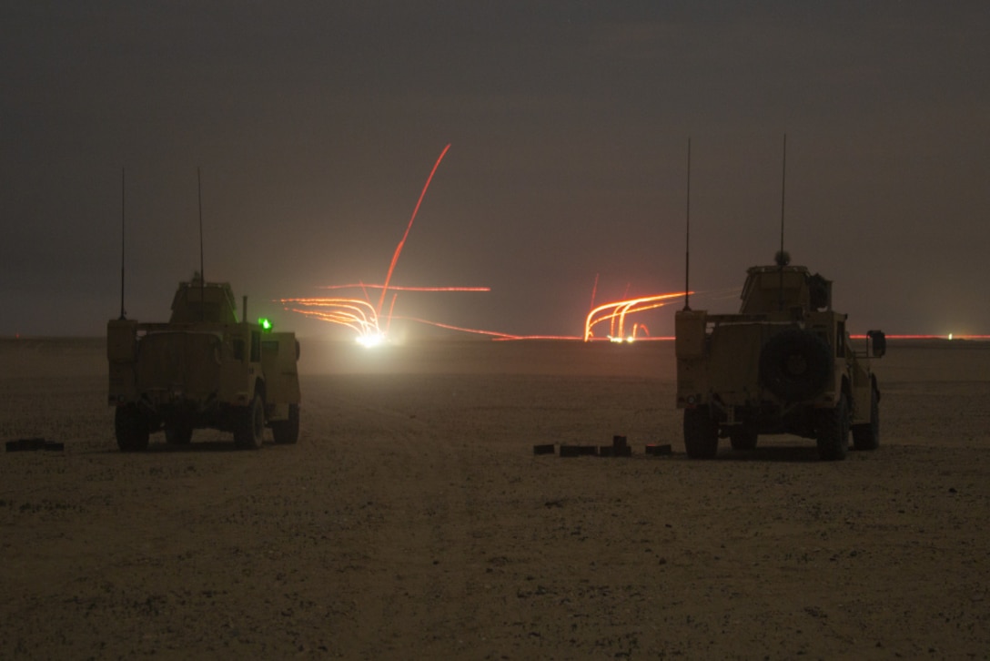 Marines in joint light tactical vehicles assigned to Combined Anti-Armor Team 3, 15th Marine Expeditionary Unit, provide machine gun suppression in support of a company non-illuminated night attack exercise during a theater amphibious combat rehearsal (TACR) at Camp Buehring, Kuwait, Feb. 22.